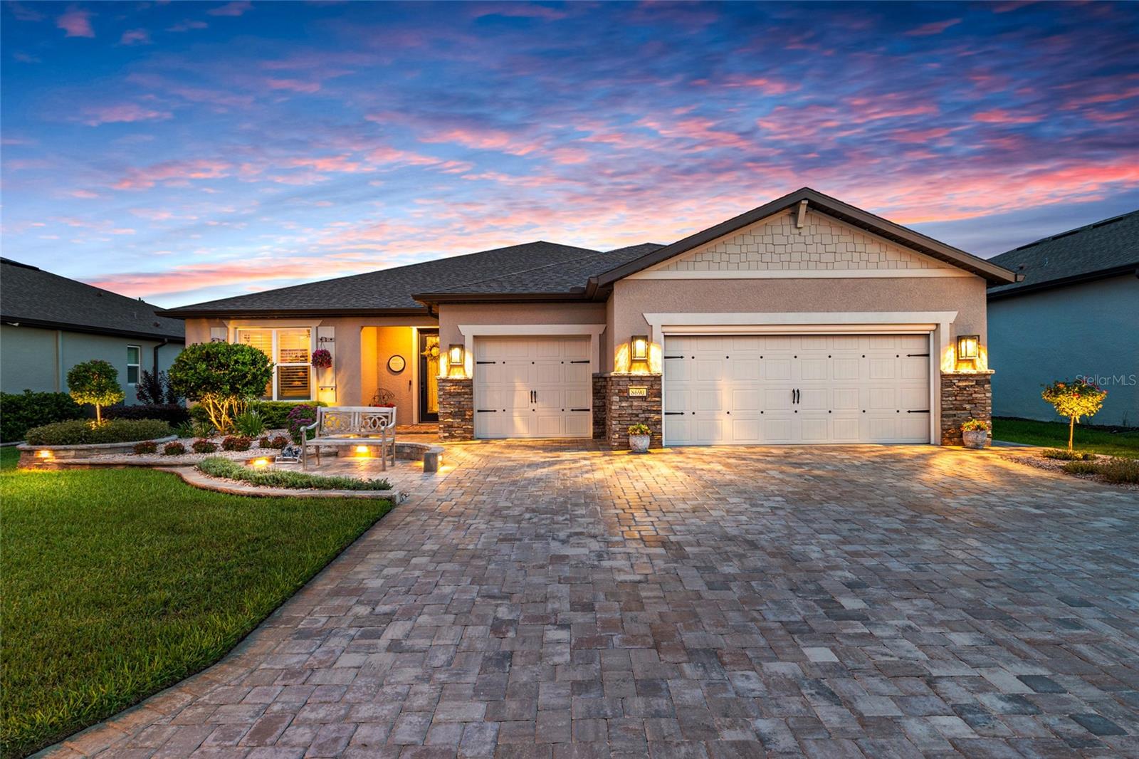 "Fairway Estate”—a truly exceptional Stardom model offering a rare combination of refined design, resort-style outdoor living, and unparalleled craftsmanship in Del Webb Stone Creek, America’s #1 Del Webb community.
Perfectly positioned along the 10th hole and within close proximity to the community’s premier amenities, including the Stone Creek Golf Club and Grille, this stunning 2-bedroom, 2.5-bath residence spans 2,261 square feet and was thoughtfully designed to showcase seamless indoor-outdoor living.

Upon entry, expansive disappearing glass doors create a breathtaking connection to the outdoors, revealing a private saltwater pool retreat surrounded by upgraded pavers, a relaxing sun shelf with dual umbrella areas, and a fully equipped outdoor kitchen featuring a granite-topped grill, refrigerators, and custom cabinetry. The panoramic screen enclosure provides unobstructed golf course views, creating the perfect backdrop for entertaining or enjoying tranquil evenings overlooking the fairway.

Inside, every detail reflects intentional design and elevated living. The gourmet kitchen is appointed with quartz countertops, under-cabinet lighting, a custom pantry, backlit display shelving, and premium finishes throughout. Additional upgrades include crown molding, upgraded lighting fixtures, upscale ceiling fans throughout the home, custom-designed closets, a built-in electric fireplace, integrated surround sound, and thoughtful touches that enhance both comfort and style.

The primary suite and guest suite each serve as private retreats, complete with spa-inspired en-suites, oversized walk-in showers, private baths, and custom-designed closets with exceptional finishes.

The thoughtfully designed garage features epoxy flooring, abundant storage solutions, overhead storage, a dedicated golf cart bay, and underground gutter systems engineered for Florida’s climate.

From the meticulously designed exterior lighting and curated hardscape to the refined interior finishes and exceptional outdoor living spaces, this one-of-a-kind residence represents the perfect balance of elegance, comfort, and functionality—

a home created for those who appreciate living the "Del Webb Lifestyle."