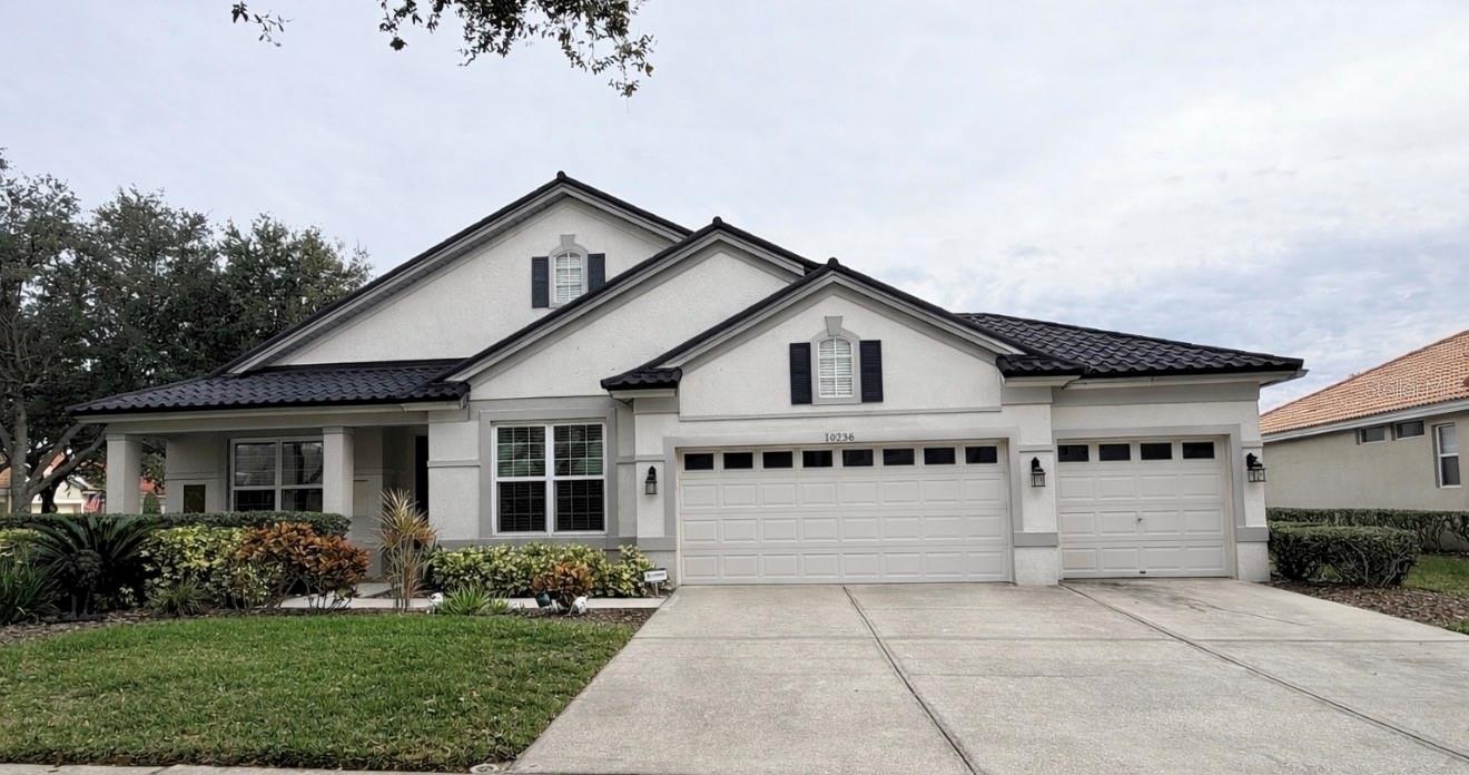 Welcome to your dream home! Located in Arbor Greene, one of New Tampa’s premier 24-hour guard-gated communities, this exceptional 4-bedroom, 3-bath home with a private office and 3-car garage offers luxury, comfort, and resort-style living. Situated on an oversized corner lot, the home features a new metal roof (2026) and fresh exterior paint (2026), providing outstanding curb appeal and peace of mind.

Inside, soaring ceilings and an open floor plan create a bright, inviting atmosphere. The formal living and dining rooms have been transformed into an expansive game and recreation area, perfect for entertaining. Behind French doors, the private office with crown molding offers an ideal work-from-home space. The chef’s kitchen features Corian countertops, an impressive 8-foot center island, tile backsplash, gas range, stainless steel appliances, 42-inch maple cabinetry, two oversized pantries, and a spacious breakfast nook. A versatile tech station turned into dry bar with built-in desk and extensive cabinetry adds exceptional functionality. The family room with custom built-ins overlooks the spectacular outdoor living area.

The owner’s retreat offers a custom feature wall, oversized walk-in closet with additional storage, and a spacious en-suite bath. Generously sized secondary bedrooms provide comfort for family and guests.

Step outside to your private backyard oasis featuring an expanded screened lanai with paver decking, a heated pool and spa, and plenty of space to relax or entertain year-round.

Arbor Greene residents enjoy outstanding amenities including multiple community pools, a state-of-the-art fitness center, tennis and pickleball courts, playgrounds, scenic walking trails, and a beautiful clubhouse. Conveniently located near USF, major hospitals, Tampa Premium Outlets, top-rated dining, and with easy access to I-75 and I-275, this home offers the perfect blend of luxury, lifestyle, and convenience. Don’t miss this incredible opportunity to own one of New Tampa’s finest homes!