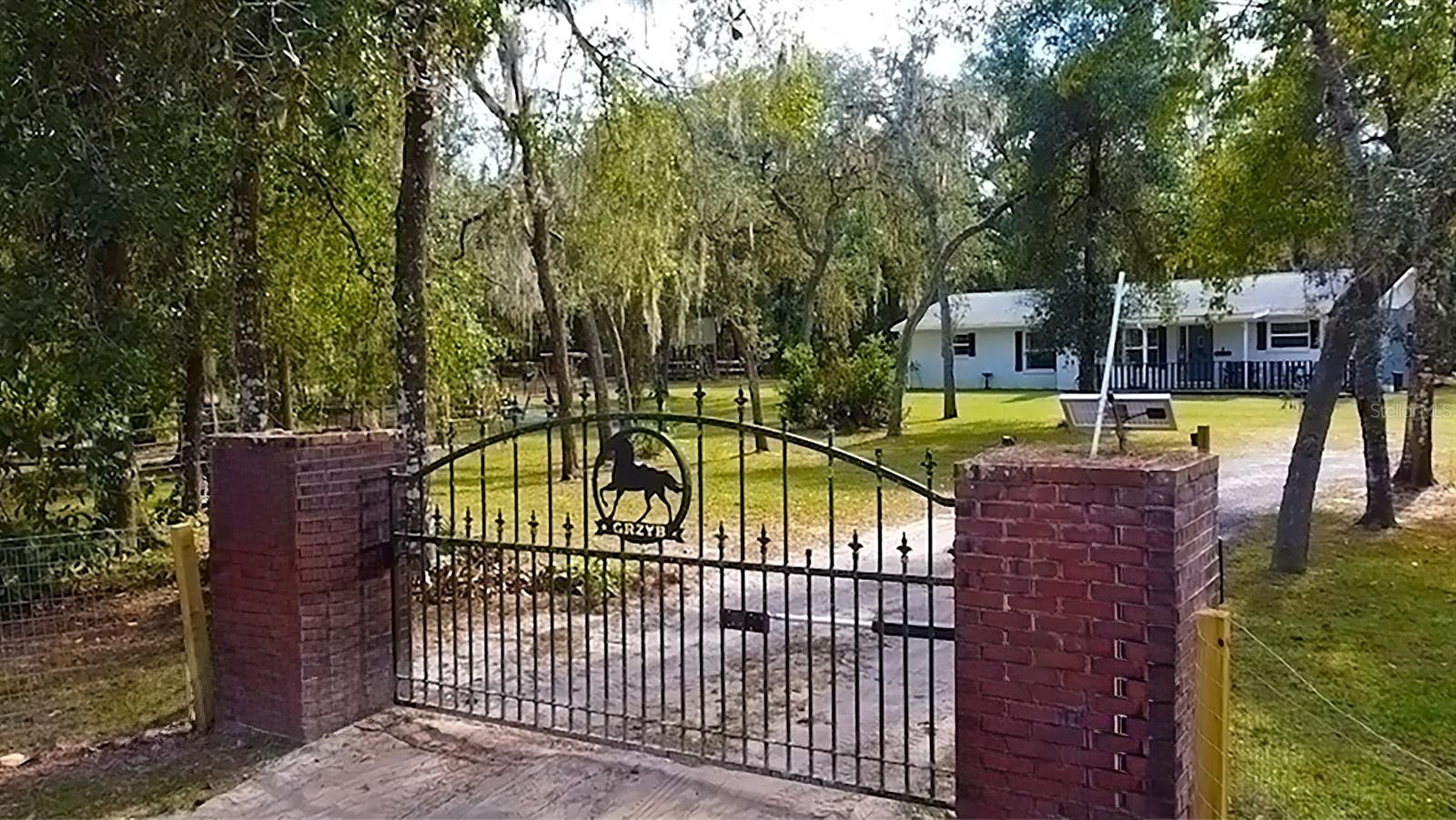 Discover the joy of country in this charming 3-bedroom, 2-bath farmhouse nestled on 2.6 acres of pure natural beauty. As you step onto this property, you'll be greeted by the inviting embrace of a fully fenced landscape, complete with two electronic entry gates, ensuring your privacy and safety. The vast night sky, adorned with bright stars and moonlight, bathes the surroundings in a magical atmosphere that simply cannot be replicated. 

Inside, the farmhouse opens up to reveal a welcoming and open floor plan. Picture cozy evenings by the wood-burning fireplace in the living room, and an additional Florida room that beckons you to relax and unwind. This home has been thoughtfully updated with newer paint, appliances, roof, windows, and beautifully renovated bathrooms.

But there's more to this country haven than meets the eye. For the hobbyist or DIY enthusiast, there's a pole barn, two sheds (one with electricity, AC and a finished interior - perfect for a man cave, she shed or office), and a pavilion hangout area with a slab floor. There's also a small horse stable and a separate fenced-in area, ideal for your beloved farm animals. This property caters to your every need.

The split floor plan offers the convenience of indoor laundry, making everyday chores a breeze. In this peaceful neighborhood, you'll find wonderful neighbors and fertile soil, making it a prime location for farming enthusiasts. Quick access to I-75 is just a 4-minute drive away, ensuring you're well-connected to nearby towns.

When it's time for shopping, you're in luck. Besides Downtown Dade City, Brooksville, and Bushnell, all just a short drive away, providing easy access to all your shopping needs, you'll find the convenience of Winn Dixie/Aldi's located just 2.5 miles away. Yet, the country charm remains untouched, offering a quiet and serene lifestyle within reach of modern conveniences.

For nature enthusiasts, the Withlacoochee State Park is a mere 4 minutes away, offering endless opportunities for outdoor adventure. The Withlacoochee State Trail, along with various trailheads, is also just minutes from your doorstep. And if you're an ATV enthusiast, you'll love being only 8 minutes away from the Croom ATV trails.

Embrace the joys of farm living with fresh eggs, happy animals, and the opportunity to cultivate a flourishing garden. With multiple farmers' markets nearby and a delightful Mexican restaurant just a mile away, you'll have everything you need to savor the delightful rural life. This is your chance to make this nature lover's paradise your very own. Don't miss out on this extraordinary opportunity!