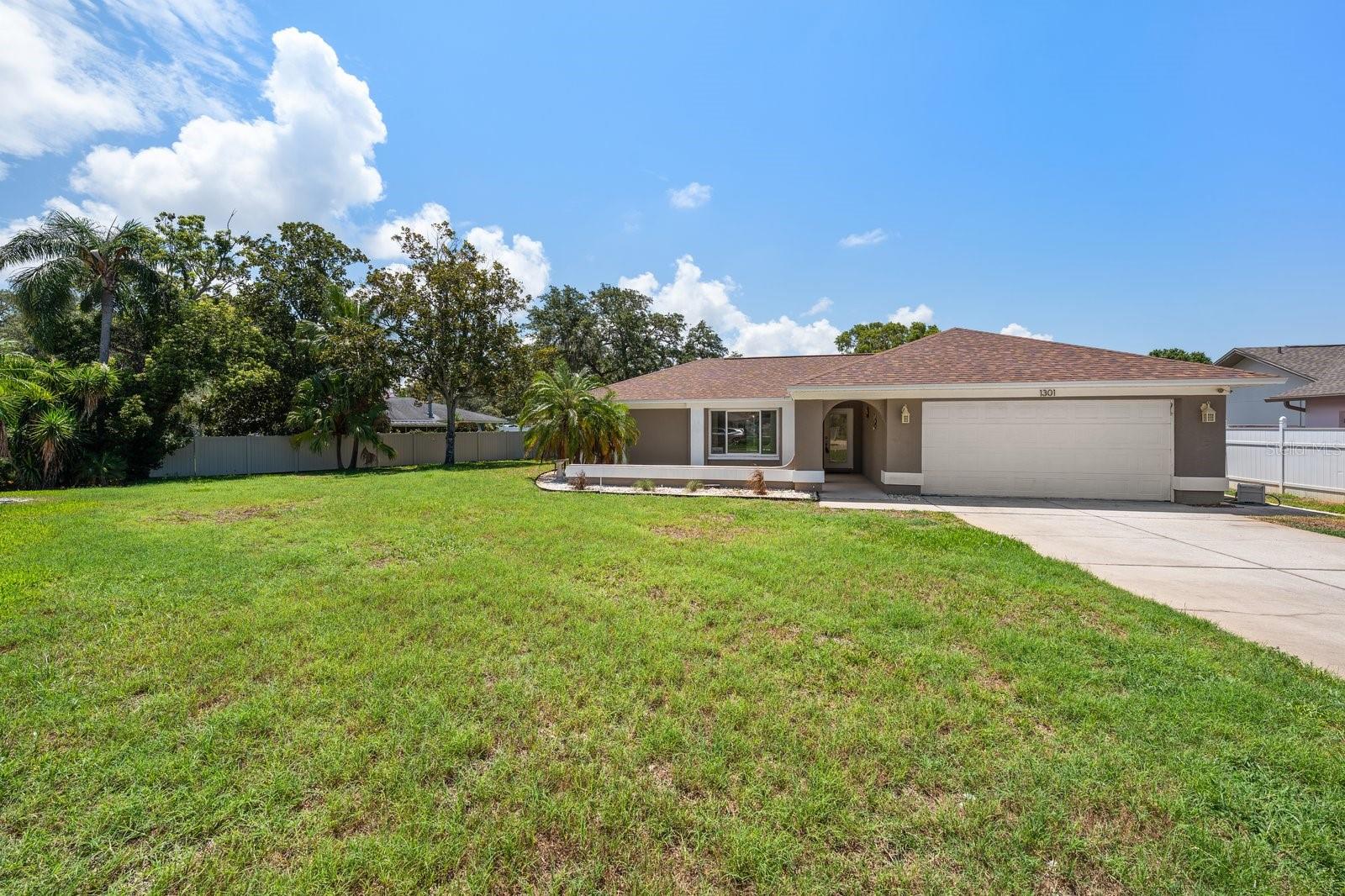 Virtually Staged. Exceptional opportunity to own this solid block pool home situated on an oversized .35-acre cul-de-sac lot with NO HOA and located in a non-flood zone. Offering the perfect combination of space, functionality, and peace of mind, this residence features 3 bedrooms, 2 full baths, and a desirable two-way split floor plan designed for comfortable everyday living. The layout includes two separate living areas, providing flexibility for entertaining or creating a home office or media space. Three sets of sliding glass doors seamlessly connect the interior to the screened outdoor living area, making it easy to enjoy Florida’s indoor-outdoor lifestyle. The private primary suite is tucked away from the secondary bedrooms and offers direct access to the pool, along with an en suite bath. The guest bedrooms are generously sized and share a full bath with a tub/shower combination. An inside laundry room adds to the home’s convenience. Step outside to your screened saltwater pool, complete with a newer screen enclosure, offering the perfect setting for year-round enjoyment. Major system updates have already been completed, including a new roof (2025), A/C (2020), hurricane-impact windows and sliding glass doors, newer electrical panel, newer water heater, and water softener. The irrigation system is supplied by a private well, helping keep landscaping costs low. With all the major improvements already in place, this home offers an outstanding opportunity for its next owner to personalize the cosmetic finishes and create their own vision, while enjoying the confidence of updated mechanical systems and an exceptional location.