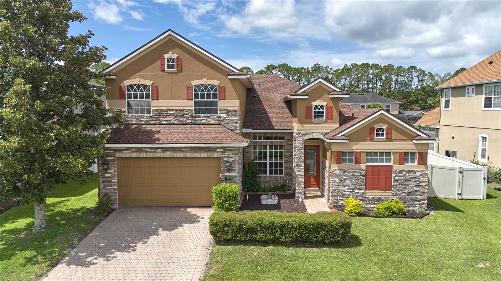5058 Otters Den Trail is located in Preserve at Astor Farms, a beautifully maintained gated community in Seminole County. Offering the perfect balance of elegance, functionality, and flexibility, this beautifully maintained residence is surrounded by mature oak trees, scenic ponds, and lush landscaping that create a peaceful place to call home.

Situated on a generous 9,600 SF (.22-acre) homesite, this 5-bedroom, 4-bathroom pool home offers 2,833 square feet of thoughtfully designed living space with a versatile floor plan that is becoming increasingly difficult to find. Designed for both everyday living and multigenerational flexibility, the home features four bedrooms and three full bathrooms on the main level, along with a private upstairs in-law suite offering its own spacious bedroom, full bathroom, walk-in closet, oversized flex/living area, and a dedicated HVAC system that has seen very minimal use over the years. Whether accommodating extended family, long-term guests, a college student, or serving as a private home office or media room, this exceptional space offers endless possibilities.

From the moment you arrive, you'll appreciate the home's inviting curb appeal. Stone accents, mature landscaping, and a beautiful paver driveway create a timeless first impression. Inside, soaring ceilings, abundant natural light, and a thoughtful combination of formal and casual living spaces create a warm and inviting atmosphere that is both comfortable and functional. The spacious kitchen opens seamlessly to the family room and breakfast nook, creating the perfect gathering place for everyday living and entertaining, while the formal living and dining rooms provide additional space for special occasions.

Step outside to your own private Florida retreat featuring a sparkling screened pool, an expansive brick-paver lanai, and mature landscaping that provides both beauty and privacy—perfect for relaxing or entertaining year-round.

Perhaps this home's greatest advantage is that many of the most significant and expensive improvements have already been completed. Recent updates include a NEW Roof (2024), NEW Main HVAC System (2024), Fresh Exterior Paint (2024), and a Brand-New Pool Screen (2026). The home has been meticulously maintained, allowing its next owner to enjoy these major improvements immediately while updating cosmetic finishes over time to reflect their own personal style.

Ideally located just minutes from Interstate 4 and State Road 429, this exceptional home provides easy access to Lake Mary, Mount Dora, Historic Downtown Sanford, shopping, dining, healthcare, and Central Florida's many attractions. Residents of Preserve at Astor Farms enjoy beautifully landscaped streets, scenic ponds, and a peaceful gated setting while remaining close to everything Central Florida has to offer.

A rare opportunity to own a thoughtfully designed pool home with a private upstairs in-law suite in one of Sanford's most sought-after gated communities. Welcome to 5058 Otters Den Trail.