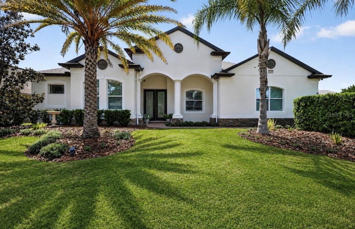 One of more photos have been virtually staged. Welcome to the sought-after Lakes of Mount Dora, one of Central Florida’s premier 55+ gated communities. Where resort-style living meets timeless elegance in this stunning Medallion Homes Barbados model!! Situated on a premium corner lot, this RARE EXPANDED FLOOR PLAN offers spacious 4-bedrooms, 3,159 square feet of living space, a private office/den and an OVERSIZED bonus/media room, offering the perfect blend of comfort, flexibility, and luxury. NEW ROOF (2025) to help with insurance costs and better protection against Florida weather. Designed with both entertaining and everyday living in mind, the home showcases NEW hardwood floors and 5" baseboards (NO CARPET), tray ceilings, NEW interior and exterior paint, and beautiful plantation shutters throughout. The gourmet kitchen is a true centerpiece, complete with stainless steel appliances, a gas stove, Butler’s pantry, bar area, and abundant cabinetry for storage and style. The spacious primary suite is enhanced with custom California Closet-style built-ins, while thoughtful upgrades throughout the home include a NEW roof, NEW tankless water heater, NEW dishwasher, NEW refrigerator, water filtration systems, ADT security system, and refreshed landscaping. Step outside to enjoy the covered and screened in back patio with partial water view featuring upgraded lighting and ceiling fans — the perfect place to relax year-round, enjoy BBQ, or a simple glass of wine after a long day. Residents have access to exceptional resort-style amenities including an 18,000-square-foot clubhouse, resort pool and hot tub, tennis courts, pickleball courts, fitness center, arts and crafts room, game room, billiards room, library, social hall, scenic walking trails, and fenced gated RV and boat parking. The HOA also includes cable, internet, and reclaimed irrigation water for lawn care convenience. Just a few minutes to the charmful Historic Downtown Mount Dora, downtown Tavares, 1 hour to east coast beaches, and 45 minutes to downtown Orlando. This is more than just a home — it’s a lifestyle opportunity in one of Mount Dora’s most desirable active adult communities.