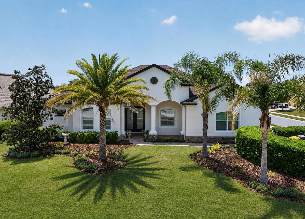One of more photos have been virtually staged. Welcome to the sought-after Lakes of Mount Dora, one of Central Florida’s premier 55+ gated communities. Where resort-style living meets timeless elegance in this stunning Medallion Homes Barbados model!! Situated on a premium corner lot, this RARE EXPANDED FLOOR PLAN offers spacious 4-bedrooms, 3,159 square feet of living space, a private office/den and an OVERSIZED bonus/media room, offering the perfect blend of comfort, flexibility, and luxury. NEW ROOF (2025) to help with insurance costs and better protection against Florida weather. Designed with both entertaining and everyday living in mind, the home showcases NEW hardwood floors and 5" baseboards (NO CARPET), tray ceilings, NEW interior and exterior paint, and beautiful plantation shutters throughout. The gourmet kitchen is a true centerpiece, complete with stainless steel appliances, a gas stove, Butler’s pantry, bar area, and abundant cabinetry for storage and style. The spacious primary suite is enhanced with custom California Closet-style built-ins, while thoughtful upgrades throughout the home include a NEW roof, NEW tankless water heater, NEW dishwasher, NEW refrigerator, water filtration systems, ADT security system, and refreshed landscaping. Step outside to enjoy the covered and screened in back patio with partial water view featuring upgraded lighting and ceiling fans — the perfect place to relax year-round, enjoy BBQ, or a simple glass of wine after a long day. Residents have access to exceptional resort-style amenities including an 18,000-square-foot clubhouse, resort pool and hot tub, tennis courts, pickleball courts, fitness center, arts and crafts room, game room, billiards room, library, social hall, scenic walking trails, and fenced gated RV and boat parking. The HOA also includes cable, internet, and reclaimed irrigation water for lawn care convenience. Just a few minutes to the charmful Historic Downtown Mount Dora, downtown Tavares, 1 hour to east coast beaches, and 45 minutes to downtown Orlando. This is more than just a home — it’s a lifestyle opportunity in one of Mount Dora’s most desirable active adult communities.