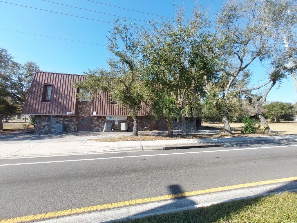 Commercial Development Opportunity

This ±2.7-acre parcel offers exceptional flexibility in one of Pinellas County’s most active commercial corridors. Zoned B-1 (General Commercial District), the property allows for a broad range of commercial uses and select residential applications, creating strong potential for mixed-use, professional office, medical, retail, service, hospitality, or flex-industrial development.

Location & Access

Situated directly on the US 19 frontage road, the site benefits from outstanding visibility and accessibility. US 19 carries approximately 60,000–70,000 vehicles per day in this corridor, providing consistent exposure and traffic flow. The property is minutes from Ulmerton Road (SR 688) and Roosevelt Boulevard, offering convenient east–west connectivity, and provides direct north–south access to St. Petersburg and Tampa.

Within a 3-mile radius, the population exceeds 70,000 residents. Within 5 miles, population surpasses 180,000, with a median household income in the 3-mile radius of approximately $60,000–$70,000. The surrounding area includes established single-family neighborhoods, large multifamily apartment communities, and a strong commercial presence, creating a stable customer base and workforce pool.

Existing Improvements & Infrastructure

The parcel includes an existing industrial/commercial structure formerly used as an HVAC service operation. The building features multiple offices upstairs and downstairs along with substantial ground-level workspace. It is suitable for continued contractor use, flex-industrial, showroom, or office conversion.

A vacant single-family residence is located on the northwest portion of the property with access from 115th Ave N. The structure may be renovated for income-producing use, utilized as interim office space, or removed to accommodate a larger redevelopment plan.

Utilities are available and currently connected. The property is located in a non-flood zone, reducing development and insurance risk. Infrastructure improvements along 58th St N support ease of site preparation and future expansion.

Development Flexibility

The B-1 zoning provides versatility to meet evolving market demands. The size, layout, and frontage of the site create opportunities for:

• Professional or medical office campus
• Retail or service center
• Flex-industrial or contractor yard
• Mixed-use redevelopment concept
• Hospitality or specialty commercial applications (subject to municipal approval)

Surrounded by residential density, established businesses, and multifamily housing, the property is well-positioned as an infill redevelopment opportunity in a mature, high-traffic corridor.

For investors and developers seeking location, scale, and flexibility in central Pinellas County, this site offers both immediate usability and long-term upside potential.