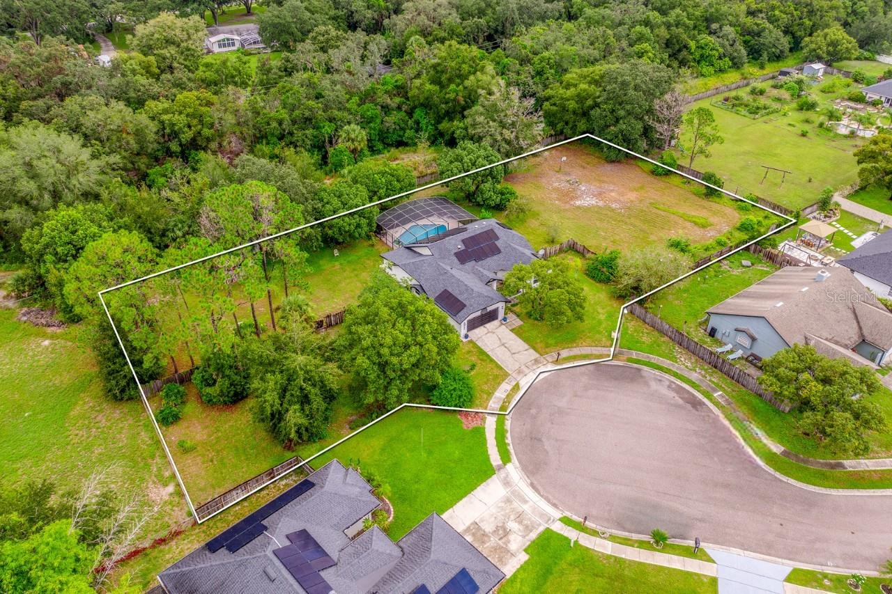 PAID-OFF SOLAR! Welcome to Sunrise Estates and your opportunity to own a truly unique property in
the heart of Winter Springs! Sitting on just **OVER AN ACRE** at the end of a quiet **CUL-DE-SAC**, this single story **POOL HOME**
combines privacy, upgrades, and location in a way that is hard to find. Major improvements bring peace of mind, starting with a NEWER ROOF (2021), UPDATED A/C (2022), NEW WATER HEATER (2022), WATER SOFTENER SYSTEM (2022) and DOUBLE PANE WINDOWS (2022). Fresh
EXTERIOR PAINT and a PAID OFF SOLAR SYSTEM keep the home looking great and your utility bills low. Inside you will be
delighted to find many updates, along with vaulted ceilings, and HARDWOOD, wood laminate and tile floors that flow throughout the functional
layout. The foyer is framed by the living and dining areas, with the living room offering a cozy fireplace and direct access to the lanai. The
UPDATED KITCHEN features sleek BOSCH STAINLESS STEEL APPLIANCES, granite countertops, complementary tiled backsplash, abundant
storage, and glass inset doors that open directly to the lanai – making INDOOR/OUTDOOR LIVING a breeze! On one side of the home three guest
bedrooms share a fully updated bath complete with exterior access, and on the opposite side your expansive PRIMARY SUITE feels like a retreat
that delivers custom blinds, a WALK-IN CLOSET and a private en-suite bath with a dual sink vanity, SOAKING TUB and separate tiled shower. A
flexible bonus space connects to your suite – ideal for a sitting room, home office, home gym or nursery, with direct access to the backyard for
plenty of natural light. Step outside and into your own private oasis – a COVERED LANAI and expansive deck overlooks the sparkling POOL and
SPA, all SCREENED and surrounded by mature trees that create a private, tranquil setting. With all the space you could ask for and a fully
FENCED YARD, there is plenty of room for play, gardening, or simply enjoying the outdoors! Irrigation is handled by a private well, while the
home connects to public water for convenience. Residents will appreciate the LOW HOA, easy access to Sunrise Community Park and the location
couldn't be better. You are just minutes from TOP-RATED SCHOOLS, shopping, dining, neighboring Oviedo and major roadways like SR 417, Red
Bug Lake Rd, Tuskawilla Rd and 426. Don’t miss the rare chance to own over an acre in Winter Springs with an updated pool home at the center
of it all. The private setting, thoughtful upgrades, and unbeatable location make this one a MUST-SEE! Call today to schedule a tour!