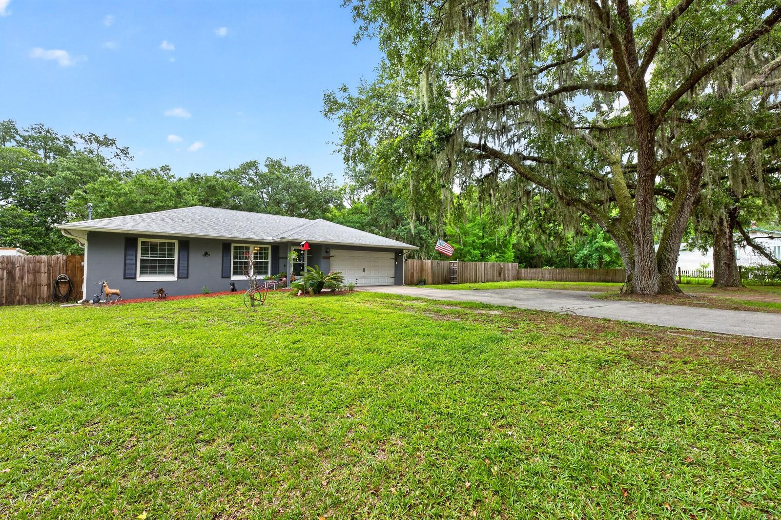 Looking for space, privacy, and flexibility without sacrificing convenience? Welcome to Pickett Woods, where this well-maintained single-story home sits on a sprawling .92 ACRE LOT surrounded by mature trees and free from HOA restrictions. With major updates already completed, including a NEW WATER HEATER (2025), UPDATED A/C (2018), upgraded insulation, a (2015) main roof, and a (2018) roof over the addition, this property offers peace of mind and room to spread out. A thoughtfully designed 2018 addition expanded the home's versatility, adding an additional bedroom, bathroom, and a flexible OFFICE/DEN/FLEX space that can easily adapt to your needs. Conveniently connected to the primary suite and kitchen, and featuring French doors leading to the lanai, this space is ideal for a home office, nursery, fitness room, hobby space, or light filled retreat. The OPEN CONCEPT layout creates an inviting atmosphere for everyday living and entertaining – the spacious kitchen overlooks the living area and features STAINLESS STEEL APPLIANCES, a breakfast bar, ample cabinet space, and a window above the sink that brings in natural light and views of the expansive backyard. With NO CARPET throughout the home, maintenance is simple and the interior feels fresh and updated. Privately situated on its own wing, the PRIMARY SUITE offers a WALK-IN CLOSET and an upgraded en-suite bath highlighted by an OVERSIZED WALK-IN SHOWER. Bedrooms two and three are located on the opposite side of the home with a full bath between them, creating a functional SPLIT BEDROOM floor plan. Step outside and enjoy the benefits of nearly an ACRE OF LAND with generous front and back yards, mature landscaping, and added privacy. A new VINYL PRIVACY FENCE is being installed to replace the existing chain-link fencing, further enhancing the outdoor space. Whether you are searching for your first home, a property with room to personalize, or a smart investment opportunity, this home checks all the boxes. Ideally located near area schools, shopping, dining, medical offices, Waterford Lakes Town Center, UCF, Oviedo, SR 50, and the 408, you will enjoy the rare combination of a peaceful setting that feels worlds away while remaining close to every everyday convenience. Call today to schedule your tour and let Pickett Woods welcome you home!