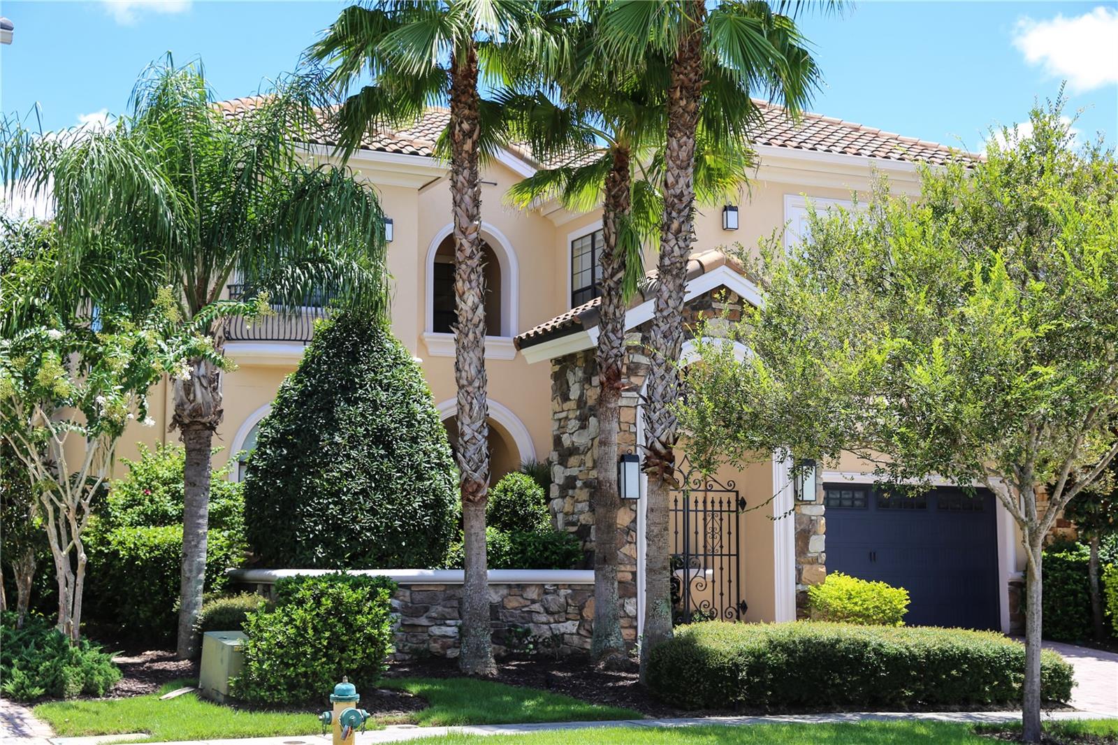 Discover a private custom estate on prestigious Muirfield Loop, a premier street lined with Reunion’s finest multi-million-dollar homes.
Now offered at $1,245,000, this immaculate residence delivers a rare blend of custom craftsmanship, generous scale, and a peaceful, low maintenance lifestyle.
Perfectly positioned on an elevated homesite with serene woods and golf views, the home offers exceptional privacy with no golfers, carts, or public walking paths directly behind your outdoor living spaces.
A gated courtyard entry opens to soaring ceilings, rich natural light, and clean contemporary design.
Enjoyed as a private second home retreat rather than a high turnover rental, the villa is in pristine, move in condition and features five ensuite bedrooms (including two ground-floor suites), multiple living areas, loft spaces, smart home automation, and fiber internet.
Outside, a pristine pool, spa, covered lanai, and fully equipped summer kitchen create a spectacular indoor outdoor entertaining oasis.
Residents enjoy a beautiful, gated resort setting with neighborhood pools, walking paths, and on-site dining, without the cost and obligation of a Reunion Club membership, keeping monthly ownership costs predictable and manageable.
Minutes from Walt Disney World and a convenient drive to Universal, area water parks, and Orlando’s premier shopping and dining, this estate combines luxury resort living, privacy, and smart value in one of Reunion’s most coveted enclaves.