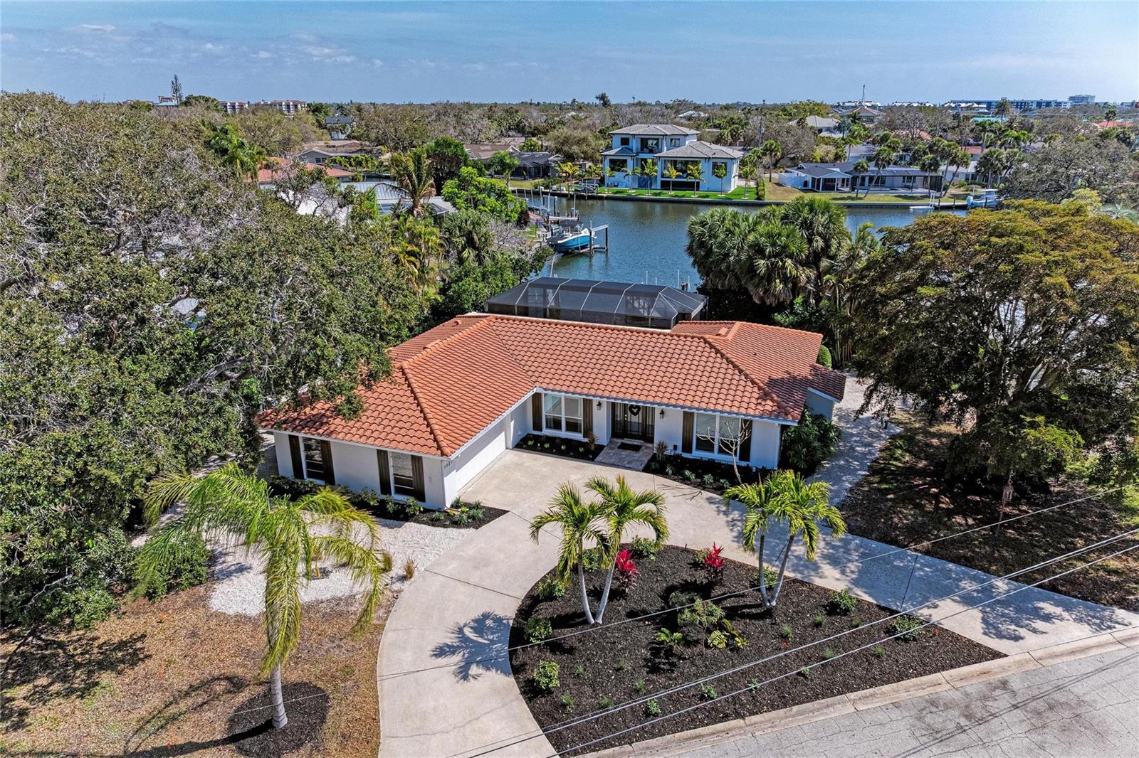A BOATER'S DREAM! Welcome to your Siesta Key waterfront dream home on a third of an acre lot! Private dock with a 7,000lb boat lift on a wide part of the Grand Canal! Move right in and start enjoying the island lifestyle! This home features great water view on the widest part of the canal! Brand new landscaping and freshly painted exterior. Sold furnished with a few exceptions. The heated pool and panoramic pool cage create a serene setting. Mostly Hurricane rated windows, new dishwasher and refrigerator, wine refrigerator, custom wood cabinets, granite counters and breakfast bar. Tile floors and engineered wood, built-out closets, open floor plan, 2 car garage, circular driveway, outdoor shower. 3 bedrooms and 3 full bathrooms plus laundry room. A few blocks from world famous SIESTA BEACH, short drive to downtown Sarasota, St Armand's, Lido and much more. ***THIS HOME HAS NOT HAD ANY STORM DAMAGE AND NO FLOODING.****BASE ELEVATION 10 Ft***SELLER MOTIVATED***