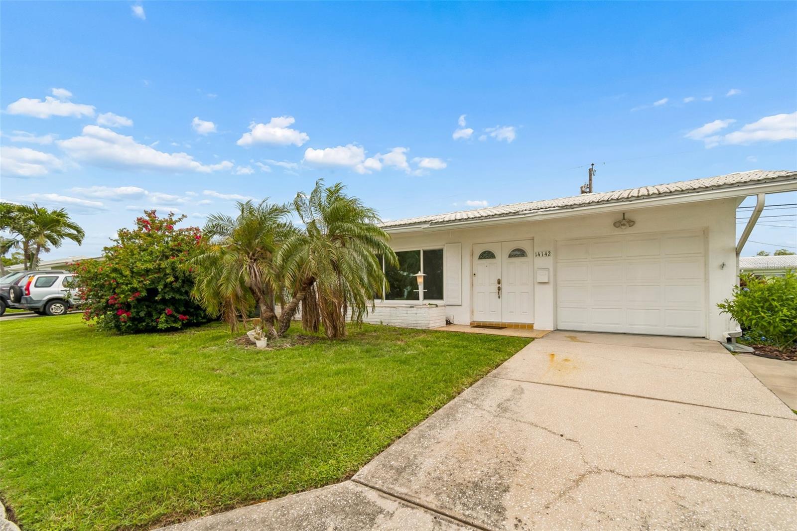 Short Sale. Welcome to Tamarac by the Gulf, one of the area's most desirable 55+ communities of single-family homes. Situated in the heart of the neighborhood, this 2-bedroom, 1-bath residence offers 1,054 heated square feet of comfortable living space and an excellent opportunity to make it your own.
Major improvements provide peace of mind, including a tile roof, gutters and downspouts, and HVAC system, all installed in 2021. The windows, two rear exterior doors, and water heater were replaced in 2020. The bathroom was updated in 2008 with a walk-in shower, grab bars, and updated toilet. Additional upgrades include an updated electrical panel. The garage laundry area features a wash tub, washer, and dryer, all replaced in 2021.
The kitchen offers wood cabinetry, a garbage disposal, microwave, range, and refrigerator. Just beyond the kitchen, the bright Florida room provides additional living space and abundant natural light, with convenient access to the backyard through an exterior door.
The attached garage offers extra storage space and houses the laundry area, while the oversized driveway provides ample parking for residents and guests.
Tamarac by the Gulf residents enjoy an exceptional lifestyle with an affordable monthly maintenance fee of just $253. The fee includes water, sewer, trash service, lawn mowing, reclaimed-water irrigation, private roads, exterior house painting approximately every 7 to 9 years, and access to the heated community pool, clubhouse, and a full calendar of social activities.
This home offers the you the opportunity to personalize the interior with your choice of flooring, paint colors, and finishing touches.  The home is being sold "AS IS".   Conveniently located near beautiful Gulf beaches, shopping, dining, medical facilities, and everyday conveniences, this is Florida living at its finest.