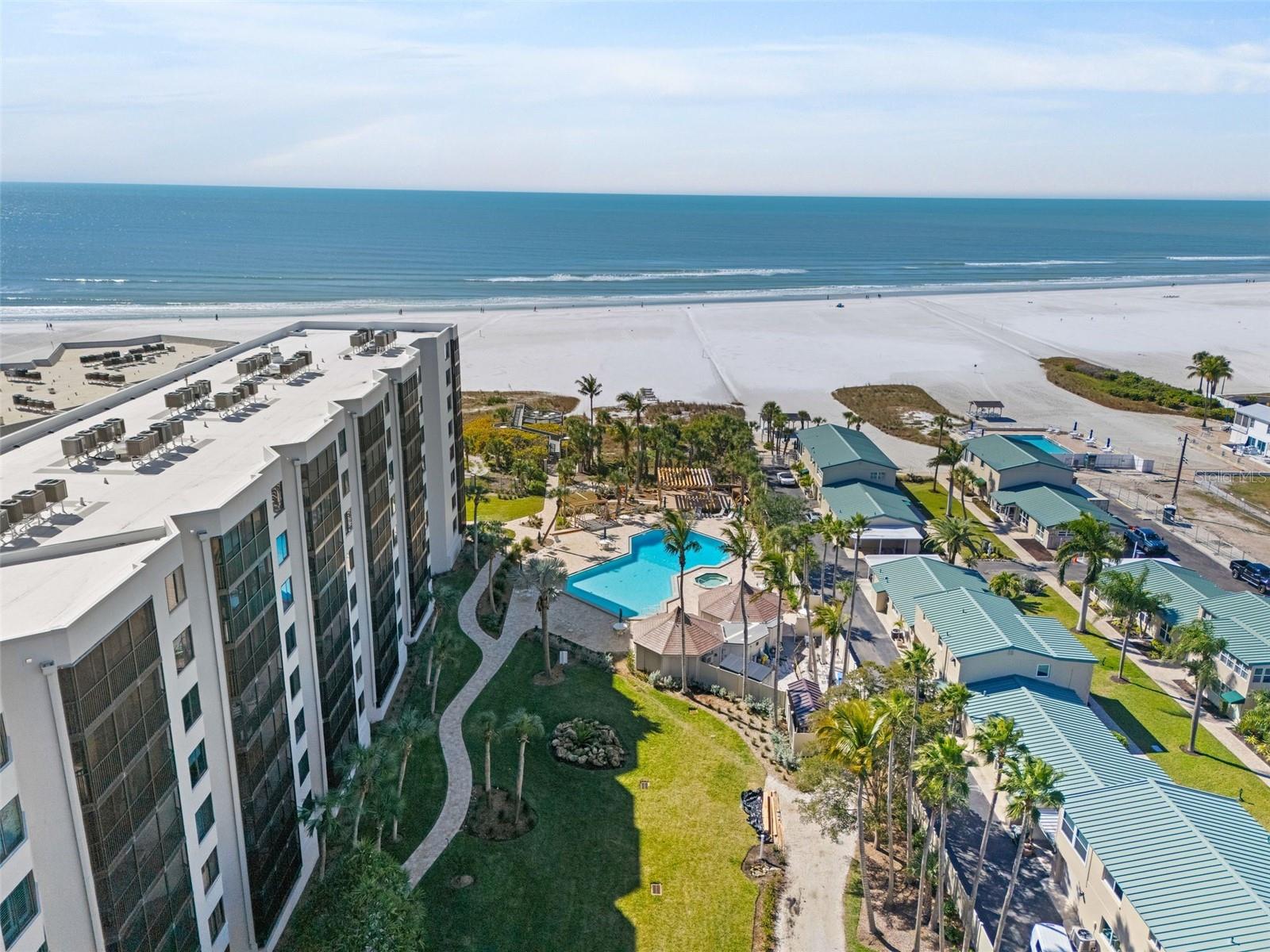 Imagine awakening each morning to the gentle symphony of waves caressing powder-white sand on Siesta Key, where the Gulf of Mexico stretches endlessly before you in shimmering turquoise splendor. This exquisite two-bedroom, two-bathroom condominium nestled within the prestigious Casarina community offers a lifestyle that transcends ordinary coastal living.

Perched elegantly upon seven acres of lush, tropical grounds directly on world-renowned Crescent Beach, this beautifully updated residence delivers the quintessential beach sanctuary you have been dreaming of. Hurricane impact windows provide peace of mind while framing breathtaking beach and gulf views that will steal your breath daily. The thoughtfully renovated kitchen boasts stainless steel appliances, while sophisticated stone-look tile graces the lanai, creating a seamless indoor-outdoor retreat.

Beyond your private haven, Casarina's resort-caliber amenities rival the finest destinations. An expansive heated pool and spa with cabana and outdoor kitchen beckons lazy afternoons, while two grilling areas invite convivial gatherings under swaying palms. A sunset beach-side deck transforms evenings into pure magic, and lighted tennis and pickle-ball courts satisfy your competitive spirit.

The community thoughtfully provides an on-site management office, fitness room, and generous community center for celebrations and social events. Just moments away, the charming Siesta Key Village offers eclectic dining and boutique shopping, while Phillippi Estate Park provides serene natural escapes.

Whether you envision this as your permanent paradise or a cherished seasonal retreat, this freshly repainted gem delivers beach-side living at its absolute finest. Schedule your private showing today and let the Gulf whisper your name.