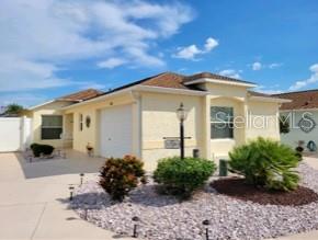 Charming Villa in The Villages with great layout, and close to everything! As you enter the property, the well-landscaped entrance shows true pride of ownership. This lovely 3 bedroom, 2 bathroom home features a large master bedroom, an open floorplan with vaulted ceilings, and easy-living laminate flooring in the main living area. The all-weather enclosed lanai can be enjoyed year round! The open kitchen has a breakfast bar and Stainless Steel appliances. There are Solar tubes for extra light and the A/C has been updated (2018) as well as a new roof in 2015. In addition, the washer and dryer come with the home! You will enjoy the large, lovely landscaped and fenced backyard for years to come - don't wait on this charmer!