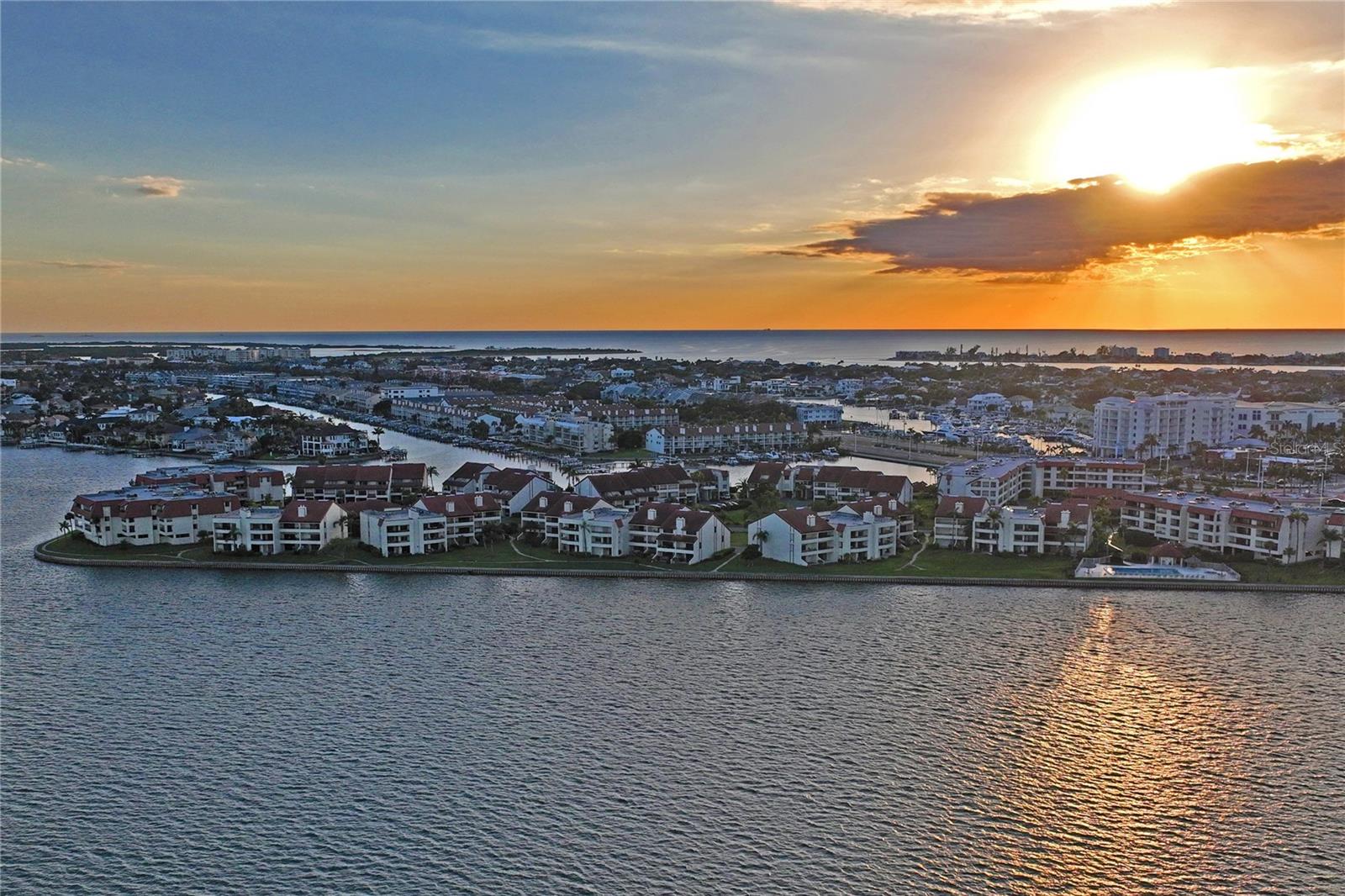 WATERFRONT LUXURY IN THE PRESTIGIOUS VILLAGE AT TIERRA VERDE!

Experience the ultimate Florida lifestyle in this beautifully updated waterfront residence located in one of Tierra Verde’s most desirable gated communities. With stunning water views, upscale finishes, and resort-style amenities, this exceptional 2-bedroom, 2.5-bath condominium offers the perfect blend of luxury, comfort, and coastal living.

Step inside to discover rich Brazilian cherry hardwood flooring, elegant designer tile, and a spacious open-concept floor plan designed to maximize both natural light and breathtaking waterfront scenery. The gourmet kitchen is a chef’s dream, featuring custom oak cabinetry, stone countertops, and premium Viking appliances that make entertaining effortless.

The formal dining room showcases an impressive coffered ceiling and picturesque water views, creating the perfect setting for intimate dinners and special gatherings. The inviting living area is highlighted by a cozy electric fireplace, adding warmth and ambiance year-round.

Retreat to the luxurious primary suite, where a private balcony offers the ideal place to enjoy morning coffee, coastal breezes, and spectacular sunsets. Four balconies and an expanded patio provide multiple outdoor living spaces to relax, entertain, and take in the tranquil waterfront setting.

A versatile bonus room with a full bath offers endless possibilities as a home office, media room, fitness space, or guest retreat. Additional features include hurricane shutters, impact-rated sliding doors, a newer A/C system (2019), a two-car garage, and an additional covered carport.

Residents of The Village at Tierra Verde enjoy an unparalleled resort-style lifestyle with three heated pools and spas, tennis courts, a fitness center, clubhouse, scenic walking and biking trails, and 24-hour gated security. The HOA fee includes water, cable, internet, sewer, trash, and exterior maintenance for exceptional convenience and value.

Located just minutes from world-renowned Fort De Soto Park, St. Pete Beach, waterfront dining, marinas, and vibrant downtown St. Petersburg, this home offers the rare opportunity to enjoy peaceful island living without sacrificing access to everything Tampa Bay has to offer.

Waterfront views, luxury upgrades, resort-style amenities, and an unbeatable Tierra Verde location—this is the Florida dream you've been waiting for. Schedule your private tour today before this exceptional opportunity is gone.