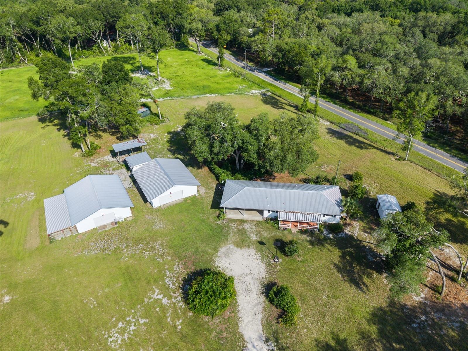 Virtually Staged. This is the kind of 5-acre setup that does not come around often. Sitting on a fully fenced 5.04-acre corner lot in Chiefland, this solid concrete block 3 bedroom, 2 bath home offers space, privacy, major updates, and outbuildings that give you room for just about everything. Recent improvements include a newer metal roof, new HVAC, new water heater, new LVP and carpet, and new stainless steel kitchen appliances. Inside, the home has a clean, move-in-ready feel with fresh flooring, neutral finishes, a spacious main living area, and a kitchen that opens naturally into the dining/living space.

Outside is where this property really shines. Two 30x30 garages with electric, giving you excellent space for vehicles, tools, equipment, hobbies, storage, or a workshop. One garage has a full bathroom, while the second has a half bath already started. The property is also set up with newer kennel runs, a fenced pasture for horses or livestock, a chicken coop, pump house, carport, and a back shed with a double sink and floor drain that would be perfect for cleaning fish, processing game, gardening projects, or extra workspace.

With all-new perimeter fencing around the full 5 acres, there is plenty of room for animals, trailers, boats, equipment, gardens, or simply enjoying the extra space. Located in the heart of Florida’s Nature Coast, you are close to Manatee Springs State Park, the Suwannee River, Cedar Key, and everyday conveniences in Chiefland, with Gainesville and Ocala both within an easy drive. Whether you are looking for a mini farm, space for horses, a place to keep your dogs, a workshop setup, or just a quiet property with room to spread out, this one is already set up and ready for its next owner. Schedule a tour today!!!