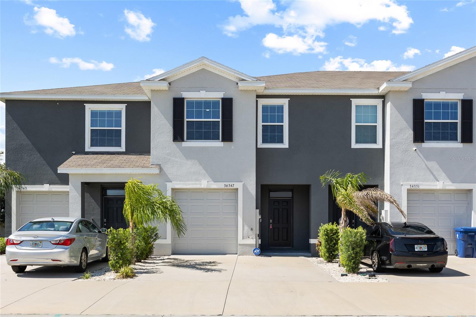 2023 BUILT | MOVE-IN READY | POND VIEWS! Welcome to this beautifully upgraded and meticulously maintained townhome located in the highly desirable Asberry Village at Summerstone community in Wesley Chapel. Offering 3 bedrooms, 2.5 bathrooms, a 1-car garage, and 1,673 square feet of thoughtfully designed living space, this move-in-ready home combines modern finishes, stylish design elements, and low-maintenance living in one exceptional package. From the moment you step inside, you'll be greeted by a stunning custom-built entryway accent wall with a functional drop zone, creating a warm and inviting first impression while adding both style and practicality. Easy-to-maintain ceramic tile flooring flows throughout the main living areas, complemented by designer accent walls in the living room and two of the upstairs bedrooms, giving the home a custom feel rarely found at this price point. The open-concept floor plan seamlessly connects the spacious living room, dining area, and modern kitchen, creating the perfect space for both everyday living and entertaining. The kitchen features stainless steel appliances, ample cabinetry, and generous counter space while overlooking the main living areas. Sliding glass doors lead to the screened-in lanai, where you can relax and enjoy peaceful pond views and a tranquil outdoor setting. A convenient half bathroom is located on the first floor for guests. Upstairs, you'll find two generously sized secondary bedrooms that share a full bathroom, along with a spacious primary suite featuring a walk-in closet and private en-suite bathroom. As an added bonus, a brand-new glass shower enclosure is being installed in the primary bathroom, further enhancing the home's modern appeal and move-in-ready condition. Residents enjoy access to Summerstone's outstanding amenities, including a resort-style pool, clubhouse, playground, basketball court, and recreational spaces designed for an active lifestyle. Conveniently located near Wiregrass Mall, Tampa Premium Outlets, top-rated restaurants, hospitals, grocery stores, and everyday conveniences, this home also offers quick access to I-75, I-275, and Morris Bridge Road, making commuting throughout the Tampa Bay area effortless. Offering modern 2023 construction, stylish upgrades, pond views, a screened lanai, and a prime Wesley Chapel location, this turnkey townhome is ready for its next owner. Schedule your private showing today! **Buyer Bonus: Our preferred lender is offering a 1% lender credit of the loan amount, up to $5,000, toward buyer pre-paids and closing costs.