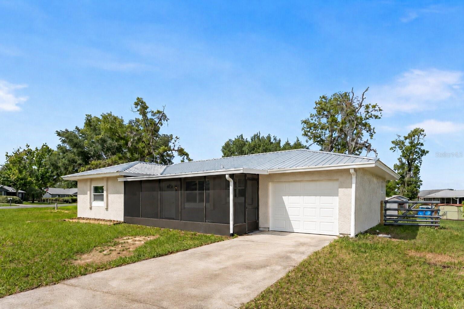 MODERNIZED HOME ON OVERSIZED CORNER LOT WITH NEW CAPITAL UPGRADES! This turn-key 2-bedroom, 1-bathroom move-in ready home is situated on an expansive, oversized corner lot. The property features major structural capital upgrades, including a brand-new metal roof, high-efficiency HVAC system, new water heater, and new energy-efficient windows throughout. The interior is updated with fresh interior paint and new modern light fixtures. The fully renovated kitchen is equipped with trending two-tone wood cabinetry, durable quartz countertops, and new stainless steel appliances. The updated bathroom features contemporary fixtures and fresh modern finishes. Outside, the property offers a massive, fully fenced backyard with a large storage shed and fresh exterior paint. Parking includes an attached 1-car garage equipped with an automatic garage door opener. Located just minutes from restaurants and shopping.
