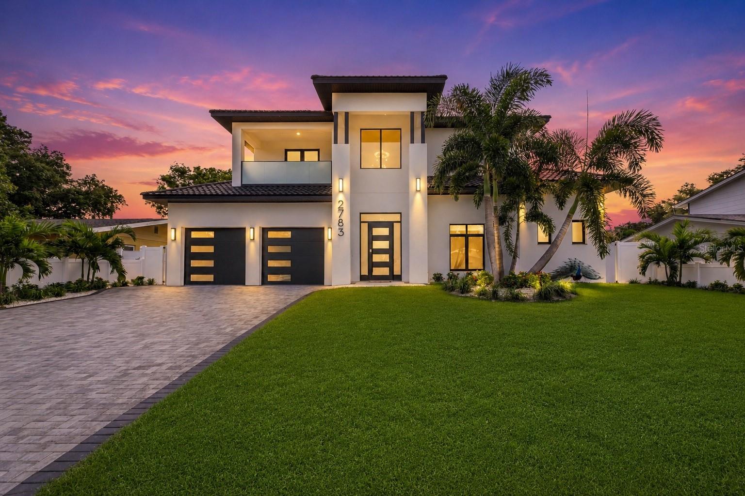 Virtually Staged. Welcome to an exceptional expression of Modern Luxury in the highly sought-after Jungle Terrace -  one of St. Petersburg’s most desirable neighborhoods where majestic peacocks roam freely. This stunning New Construction residence offers 4 bedrooms, 3 1/2 Bathrooms, a Dedicated Office, a 2-car garage and POOL thoughtfully designed with Elegant Finishes, and today’s most sought-after amenities.  A private Dedicated Office welcomes you just off the grand foyer, creating the ideal space for working from home or a quiet study. Step inside and be captivated by the dramatic 22-foot Soaring Ceilings, a striking glass-railed staircase, an Open-Concept design that fills the home with natural light. Beautiful Porcelain Tile flooring flows throughout the main living areas, creating a seamless blend of sophistication and contemporary style.  The Chef’s Kitchen is truly the heart of the home, featuring custom Wood Cabinetry, Quartz Back Splash/Countertops, Premium Stainless Steel KitchenAid appliances, Natural Gas cooking, a Built-in Wine Refrigerator, and a sit at island designed for gathering and entertaining. A second Prep Sink within the island adds convenience and functionality, making meal preparation effortless while keeping the kitchen beautifully organized.  Designed for both comfort and flexibility, this home offers two luxurious En Suite Bedrooms. The expansive First-Floor Primary Suite is a private retreat with sliding glass doors opening directly to the backyard oasis. The spa-inspired ensuite features Dual Floating Vanities, a Freestanding Soaking tub, an Oversized Walk-in Shower, and 2 Custom-Designed Walk-in Closets, providing exceptional storage and organization. Upstairs, the 2nd En Suite Bedroom offers its own private bathroom and access to a covered balcony overlooking the front of the home—an inviting spot to enjoy your morning coffee or unwind in the evening. Two additional spacious bedrooms and beautifully appointed bathrooms complete the second level, while every closet throughout the home has been outfitted with custom closet organization systems.  Step outside into your own private resort where luxury continues. The backyard showcases a Brand-New In-ground Pool with a Sun shelf, beautifully surrounded by elegant Spanish ceramic tile, professionally designed landscaping, and paver decking, creating the perfect setting for entertaining or enjoying the Florida lifestyle year-round.  Built with quality, efficiency, and longevity in mind, this exceptional home features foam-insulated exterior walls for enhanced energy efficiency and comfort, custom impact-rated windows and doors, a stunning commercial-grade front entry door, a premium European metal tile roof, natural gas appliances, a tankless gas water heater, and an epoxy-coated garage floor. Every detail has been carefully selected to provide lasting beauty, superior performance, and peace of mind.  Perfectly situated just minutes from award-winning Gulf beaches, waterfront parks, Tyrone shopping and dining, and vibrant downtown St. Petersburg, this remarkable home offers the perfect balance of luxury, convenience, and coastal living.  From its impressive architecture and thoughtfully designed floor plan to its high-end finishes and exceptional construction, this one-of-a-kind residence is truly a place you’ll be proud to call home. Schedule your private showing today and experience one of Jungle Terrace’s finest new construction opportunities.