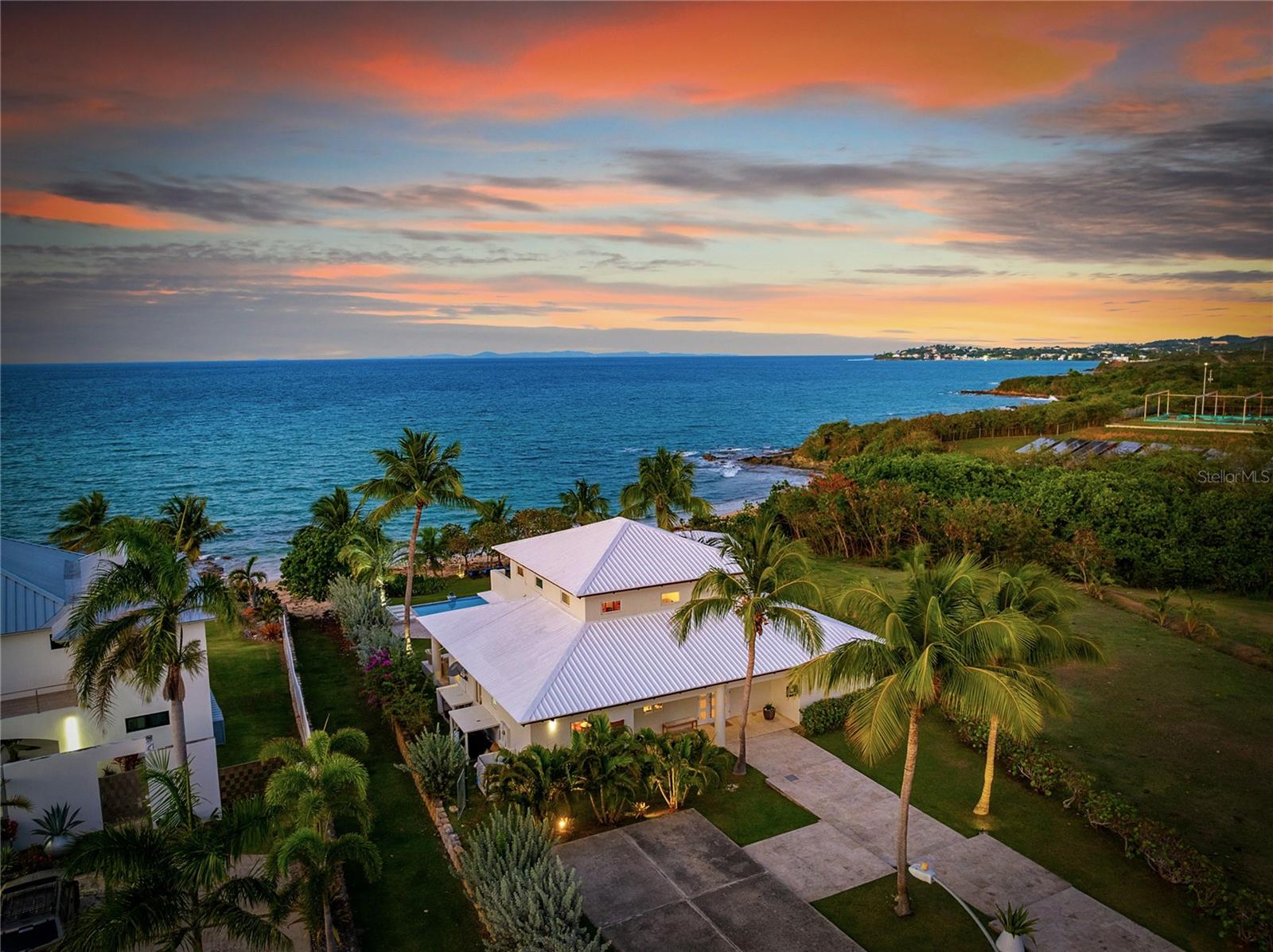 Step into unparalleled beachfront living on Vieques’ serene Atlantic shore at Martineau Belle Playa Villa, nestled within the private, gated Martineau Beach Estates. The villa is perched gracefully above its own protected stretch of golden sand, offering unobstructed views of the sea, nearby islands like Culebra and St. Thomas, and breathtaking sunrises and sunsets. An infinity-edge pool appears to merge with the ocean horizon, while a well-appointed entertainment pavilion and outdoor kitchen invite seamless indoor outdoor gatherings.

Designed with tropical elegance and laid-back luxury in mind. The interiors blend coralina marble and wood textures with open-concept living spaces, vaulted ceilings, marble and travertine flooring, and wall-to-wall windows to bring the natural beauty in Three generous bedroom suites all feature spa-inspired en-suite baths, walk-in closets, and private balconies—each capturing ocean breezes and panoramic views. The entire second-floor primary suite stretches the full width of the home and boasts a sweeping balcony with uninterrupted Atlantic vistas.

Outside, every detail enhances the island experience: multiple lounge areas, outdoor dining under a gazebo, an outdoor shower, and lush tropical landscaping creates a resort-like ambiance. With high-end amenities including zoned mini-split cooling, and a wet bar, the villa reflects refined comfort paired with Vieques’ relaxed spirit. Whether you're seeking an upscale retreat, investment opportunity, or a canvas for island events, this property delivers exclusivity, privacy, and a true connection to nature.