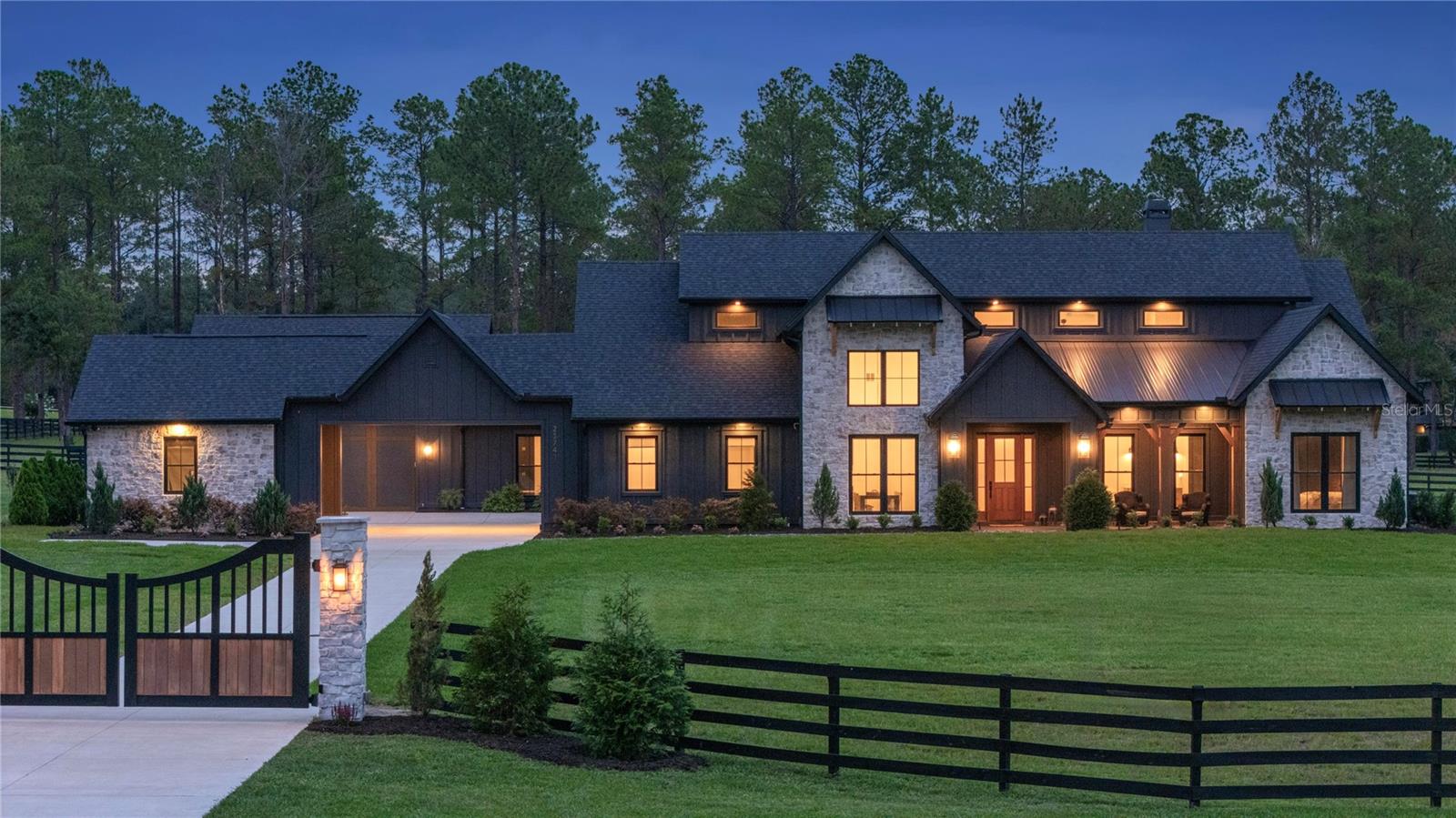 Set on five cleared, irrigated, and fully fenced acres within the equestrian community of Lakewood Ranches, this exceptional 2022 Hagedorn Custom Home combines architectural character, modern luxury, and the freedom of acreage living. The community's riding trails and spacious homesites accommodate horses, guest houses, workshops, and additional garages, creating a lifestyle rarely found in Central Florida.

Storybook-inspired architecture, dramatic roof peaks, and tall picturesque windows create a striking first impression, while vaulted ceilings, exposed wood beams, whitewashed brick accents, and exceptional craftsmanship define the interior. Designed around open-concept living, the great room and kitchen form the heart of the home, creating an inviting space for both everyday living and entertaining.

The kitchen blends beauty and function with Sub-Zero refrigeration, Wolf appliances, abundant cabinetry, extensive counter space, under-cabinet lighting, and pop-up charging stations. A full scullery adds exceptional convenience with butcher block counters, extensive storage, and a stand-up freezer.

The primary suite serves as a private retreat featuring vaulted ceilings, wood beam accents, and walls of windows overlooking the property. The spa-inspired bath offers a freestanding soaking tub, oversized shower with rain showerhead, and soaring ceilings. An additional guest suite, two bedrooms connected by a Jack-and-Jill bath, and an oversized fifth bedroom ideal as a recreation room, media room, or in-law suite provide exceptional flexibility.

A large L-shaped covered porch overlooks the expansive backyard and offers ample room for a future resort-style pool. Additional highlights include climate-controlled three-car garages, a covered portico and motor court, whole-home Sonos audio, spray foam insulation, double-pane windows, cross fencing, and a 30-kW liquid-cooled generator.

A rare opportunity to enjoy custom craftsmanship, usable acreage, and the distinctive equestrian lifestyle of Lakewood Ranches.