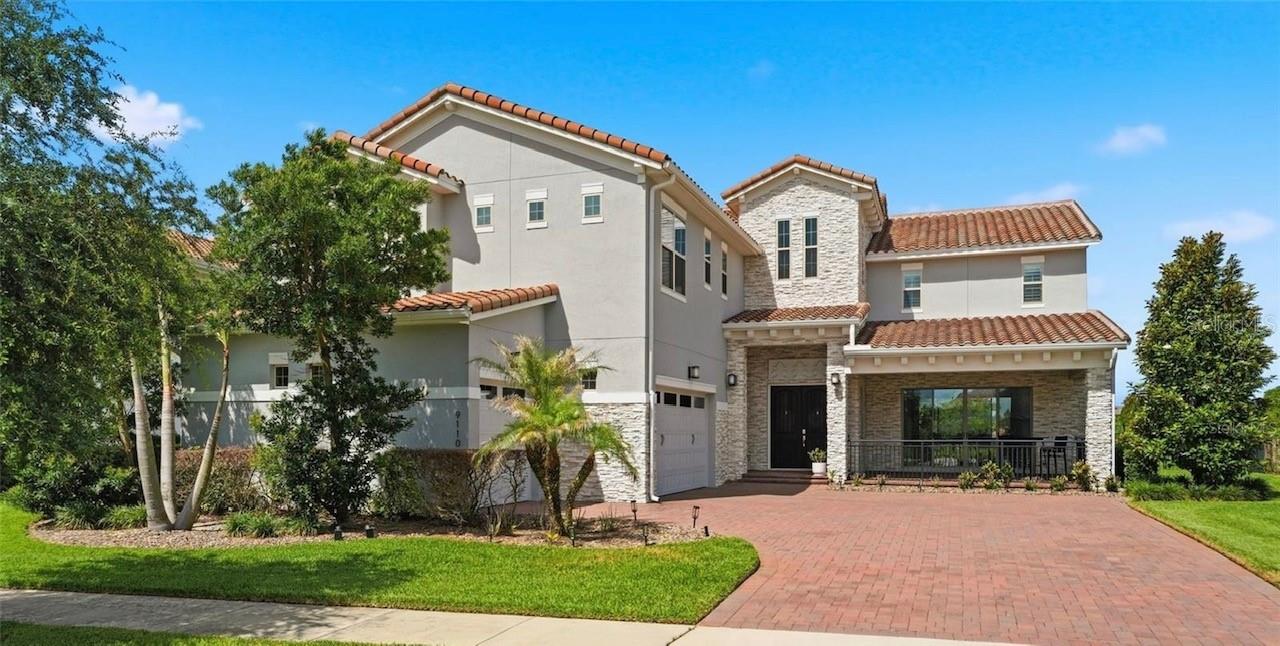 Orlando Lakefront Luxury Residence with Private Dock on Lake Hickorynut, Resort-Style Pool & World-Class Location! Welcome to 9110 Morgana Court, an extraordinary waterfront residence offering the ultimate Florida luxury lifestyle just minutes from Disney, all the Orlando world-famous attractions, championship golf, premier shopping, fine dining, and international travel connections. Perfectly positioned on a beautiful ski lake, this  5-bedroom, 5-bath residence showcases breathtaking sunset views, private covered dock, expansive outdoor living spaces, and a highly desirable floor plan designed for luxury living, entertaining, and multigenerational flexibility.  The backyard is truly a private resort featuring an oversized heated saltwater pool, relaxing 8-person spa, elegant fire feature, complete outdoor kitchen, and an expansive covered lanai with retractable screens for year-round enjoyment. Imagine spending your days boating, paddle boarding, fishing, waterskiing, or simply relaxing on your private dock while enjoying spectacular Florida sunsets over the water. Opportunities to own a true ski-lake property with this level of privacy and luxury are increasingly rare. Inside, natural light fills the home and highlights the finishes. The gourmet chef's kitchen serves as the centerpiece of the home, featuring an oversized island, premium Wolf gas range, double ovens, abundant cabinetry, and an open-concept design ideal for entertaining. The flexible floor plan offers exceptional versatility with a private first-floor guest suite complete with full bath and walk-in closet, a spacious bonus room perfect for a home office, fitness studio, media room, or additional guest retreat, plus an expansive upstairs loft opening to a private balcony overlooking the lake. The luxurious primary suite is a true sanctuary, offering panoramic water views, a spa-inspired bath, oversized walk-in shower, and an exceptionally large custom closet. Additional bedrooms are generously sized and thoughtfully positioned for privacy. Extensive upgrades include new exterior paint (2026), heated saltwater pool and spa, complete outdoor kitchen, surround sound system inside and out, retractable lanai screens, custom window treatments, upgraded stair railings, designer lighting, and fully fenced oversized homesite. Whether you're seeking a primary residence,  multigenerational retreat, or a luxury Florida lifestyle property near Orlando's most desirable destinations, 9110 Morgana Court delivers a rare combination of waterfront recreation, privacy, convenience, and resort-style living. Schedule your private tour today.