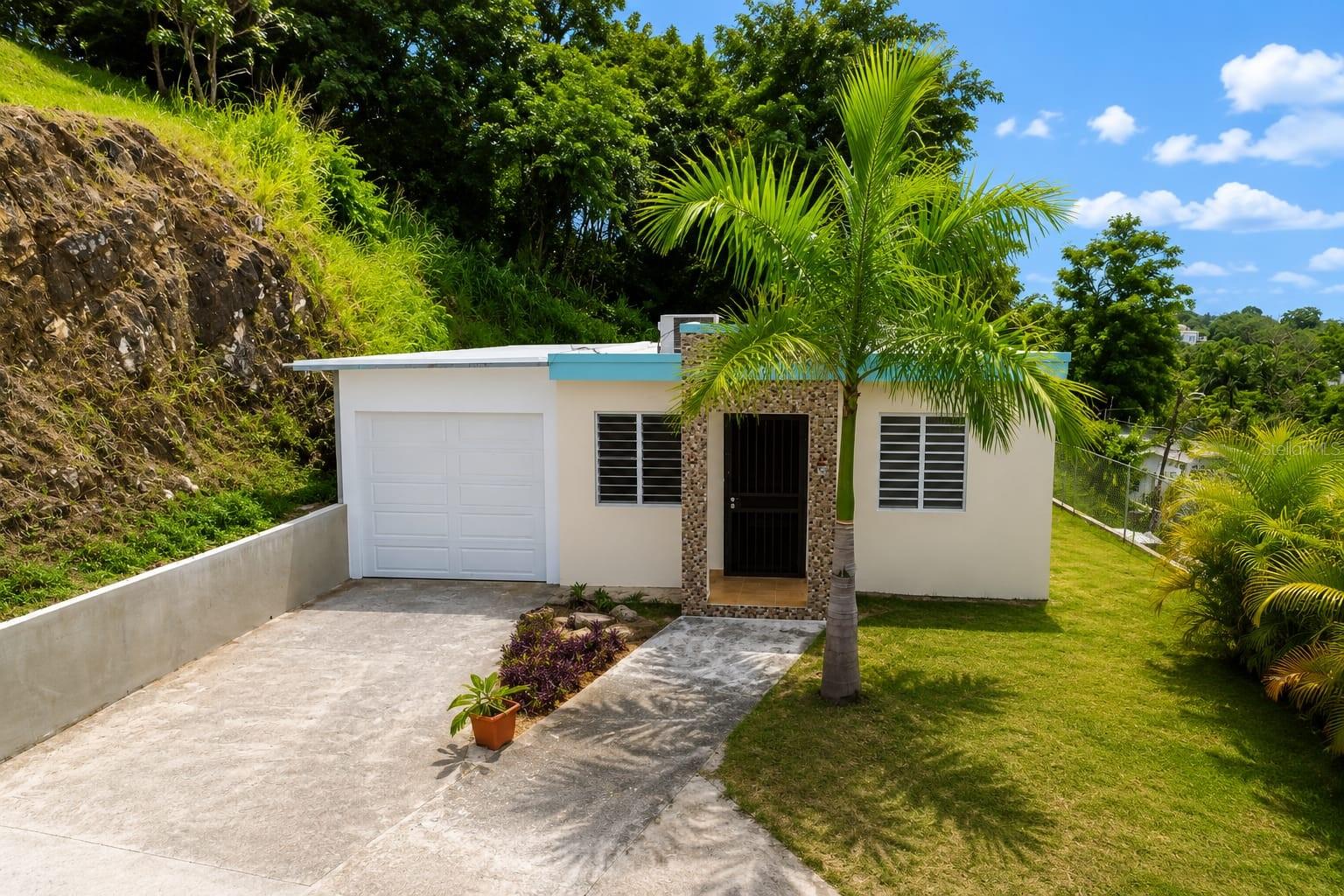 Discover this beautiful modern home in Rincon, perfectly suited from families seeking comfort, privacy and convenience. Built just 10 years ago, this well- maintained residence offers 3 bedrooms, 2 bathrooms and a functional layout designed for everyday living. Enjoy a spacious two- car garage with automatic garage doors, a dedicated laundry area, a private driveway that serves only a few neighboring homes, providing added privacy and peaceful setting.
Nestled in a quiet area just 7 minutes from downtown Rincón, you’ll enjoy the tranquility of surroundings while remaining close to beaches, restaurants, shops, and everything the town has.