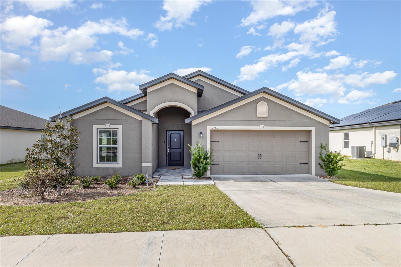 This 4-bedroom home available for rent is less than 3 years old and is located in Dundee, Florida in the desirable community of Ridge at Swan Lake. This home features an open concept floor plan, 4 bedrooms and 2 full baths complete with NEW UPGRADES such as vinyl floors in all the bedrooms (no more carpet), renovated Master Bathroom, and ceiling fans in all guest bedrooms. Don't forget the additonal original upgrades from the builder such as energy efficient appliances, spacious granite/quartz countertops, updated backsplash in the kitchen, custom wood cabinets, smart home features, water softener, brushed nickel hardware and an attached two car garage. This home has a master suite complete with a massive walk-in closet, as well as a utility room, covered back patio and front yard landscaping and irrigation. In addition, Ridge at Swan Lake offers residents beautiful nature views filled many beautiful lakes, walking/biking trails and is just minutes from fine dining, shopping, Disney World and LEGOLAND. You’ll be conveniently close to Clermont and a 30 minute drive to the Disney theme parks! Commuting or visiting any of Tampa Bay or Orlando's amazing attractions will be a breeze. Contact me today for your private tour! This home will not last.