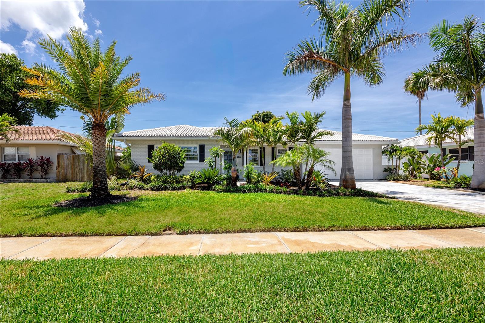 Rarely does a home at this price point offer such an uncompromising level of luxury, craftsmanship, and high-end design. Priced at $599,000, this fully renovated 3-bedroom, 2-bath residence showcases the caliber of finishes, attention to detail, and premium upgrades more commonly found in multimillion-dollar custom estates.
From the moment you arrive, the home makes a striking first impression with its freshly painted exterior, lush mature landscaping, fruit trees, and elegant brick paver front porch.
Inside, rich travertine flooring flows seamlessly throughout the home, complemented by upgraded interior doors, recessed LED lighting, and Decora switches and outlets that create a refined, cohesive aesthetic. The expansive living space is anchored by a dramatic floor-to-ceiling shiplap feature wall with a sleek recessed fireplace, delivering a sophisticated focal point ideal for both entertaining and everyday living. Additional interior enhancements include fully installed blinds throughout, custom drapery panels, and a California Closets system in the primary suite.
The designer kitchen is truly exceptional, featuring premium custom cabinetry, stunning natural quartzite countertops, and a dramatic full-height quartzite backsplash that offers the elegance of marble with superior durability. Luxury appliances include a Wolf gas range with integrated Wolf microwave drawer, Sub-Zero glass-front refrigerator, and Cove dishwasher.
Both bathrooms have been meticulously redesigned with spa-inspired finishes, featuring custom tile work, quartz countertops, dual vanities, sleek modern plumbing fixtures, updated plumbing behind the walls, illuminated mirrors, and stunning glass-enclosed walk-in showers.
Beyond the cosmetic transformation, this home has been extensively upgraded for long-term comfort, efficiency, and peace of mind. Improvements include Weathertite impact windows and doors, a natural gas Generac whole-house generator with automatic transfer switch, Eco Pure H2O water softener and filtration system, upgraded Square D electrical panel, copper plumbing updates, thermal expansion tank for the hot water heater, and hurricane-impact garage and side-entry doors.
Every detail of this move-in-ready luxury residence has been thoughtfully curated and professionally completed, offering a rare opportunity to own a truly turnkey home where no expense was spared and no detail overlooked.