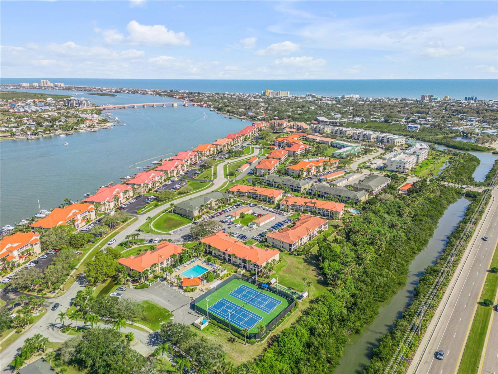 Beautifully maintained 3-bedroom, 3-bath condominium located in one of Bouchelle Island's newest buildings, completed in 2017. This third-floor residence combines newer construction, modern comfort, and low-maintenance coastal living in one of New Smyrna Beach's most desirable waterfront communities.
Barely lived in and in like-new condition, this bright and immaculate home is truly move-in ready. Offered partially furnished and turnkey, it is ideal as a primary residence, second home, or investment property.
Relax on your screened balcony overlooking a peaceful creek, where you'll enjoy abundant wildlife, tranquil surroundings, and panoramic views of Florida's spectacular space shuttle launches. While not directly on the Intracoastal Waterway, the private natural setting provides exceptional privacy and a peaceful backdrop.
Additional features include porcelain tile flooring throughout, elevator access, an assigned covered parking space, and a short walk to the community pool and pickleball courts.
Bouchelle Island offers an exceptional waterfront lifestyle with two heated swimming pools, tennis courts, pickleball courts, a clubhouse with a fitness center, a fishing pier, private boat ramp, dry boat storage, marina slips (subject to availability), and a scenic riverfront boardwalk perfect for walking, fishing, or taking in breathtaking sunsets.
Ideally located just minutes from New Smyrna Beach's pristine beaches, Flagler Avenue, Canal Street, waterfront dining, boutique shopping, and local entertainment, this home provides convenient access to everything that makes coastal living so special.
Whether you're searching for a full-time residence, seasonal retreat, or investment opportunity, this exceptional condominium offers the perfect combination of comfort, convenience, and the Florida lifestyle. Schedule your private showing today. Buyers should independently verify square footage and all information they deem important.