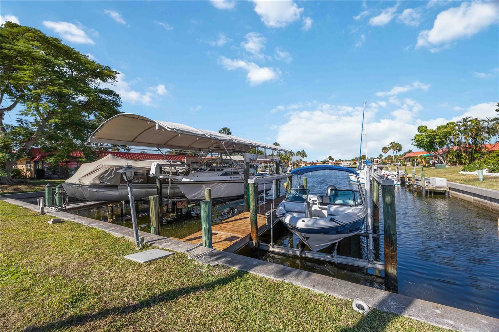 One or more photo(s) has been virtually staged. Welcome to 9608 Valencia Cove in the coveted waterfront boating community of Palma Sola Harbour. With no age restrictions and just a short drive from the pristine shores of Anna Maria Island, this two-bedroom, two-bath villa is a masterpiece of modern coastal living, brimming with luxurious updates and thoughtfully designed spaces.

Inside, you’ll find an fully remodeled open floor plan that truly sets this villa apart. Open flow through through the kitchen, living, and dining areas out to water exposure and boat access make this home perfect for both everyday living and entertaining. The kitchen is a standout with granite countertops, white shaker cabinets, and all-new GE fingerprint-resistant appliances. The entire space is illuminated by sleek LED recessed and under cabinetry lighting, adding a bright, modern touch. All of this while still remaining high and dry through 2024. NO FLOODING!

Both bathrooms have been luxuriously remodeled, featuring high-end finishes and expanded layouts that provide a sense of space and luxury beyond the standard in the neighborhood. The master suite includes a sliding glass door that opens onto the private back patio, offering a peaceful outdoor retreat.

In addition, the interior and exterior have been freshly painted, giving the home a crisp, like-new feel. There is also a private carport that includes a dedicated laundry room, a brand-new water heater, and additional storage space right within the carport area.

Not only is this villa gorgeous inside, but it also features paver driveways and a back patio that have been freshly sealed, a unique touch that adds both charm and durability. The crown jewel is the deeded boat slip right out the back door. Choose between a 10,000-pound lift with a canopy or a slightly smaller slip—both options make boating a breeze, and open water is just a short cruise away.

Palma Sola Harbour residents enjoy a wealth of community amenities, including tennis courts, multiple pools, saunas, a game room, a woodshop, a party or gathering room, a putting green, and a public fishing dock. All of this is covered by your association fees, which also include flood insurance.

In essence, this villa is not just a place to live—it's a gateway to a vibrant, waterfront lifestyle with every luxury and convenience at your fingertips.