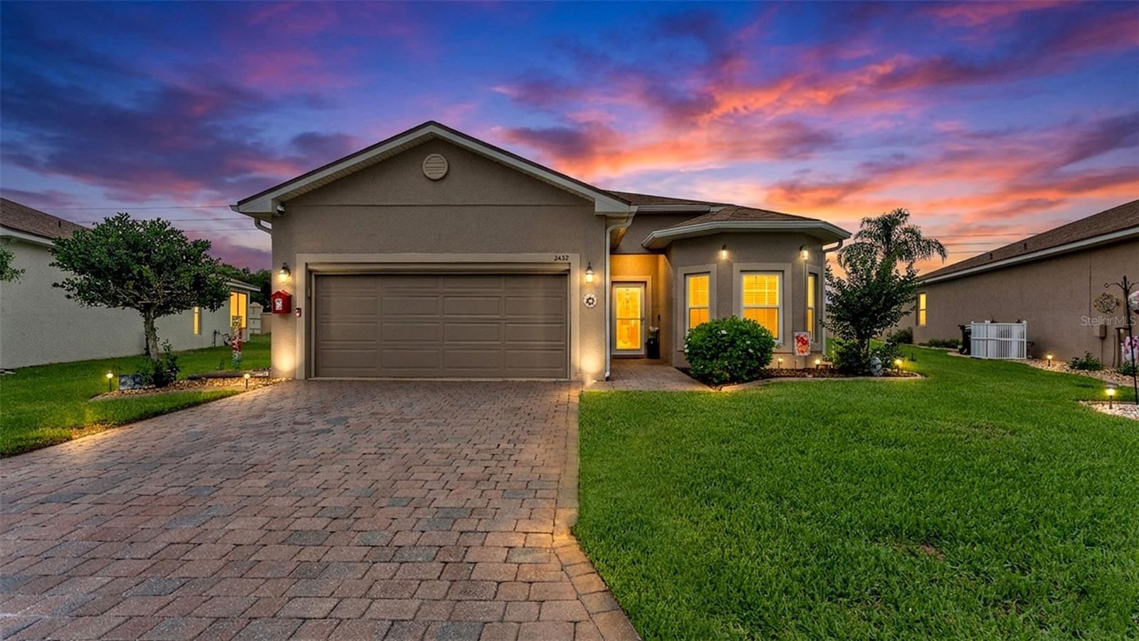 Welcome to this beautifully maintained 2-bedroom, 2-bath pool home offering 1,729 square feet of living space in Vienna Square, a sought-after 55+ gated community. One of the only pool homes in the neighborhood, this residence features a spacious open floor plan with a Kitchen/Family Room combination, Living Room/Dining Room combination, and ceiling fans throughout. Sliding glass doors from the main living area lead to the private outdoor oasis, complete with a heated, fully enclosed in-ground pool, child safety fence, large shade sails, a covered and screened rear porch, and a NEW pool pump installed in August 2025. The well-appointed kitchen offers ample counter space, custom solid wood cabinetry, solid surface countertops, upgraded stainless steel appliances, a breakfast bar, and a cozy breakfast nook surrounded by three windows that fill the space with natural light. The primary suite features an en-suite bath with dual sinks, a low-threshold shower with safety rail, and a separate water closet area for added privacy that houses the toilet and shower. In addition to the second bedroom and full bath, there is a versatile office/den/study that can easily accommodate a variety of needs. The attached 2-car garage includes multiple overhead storage shelves and retractable screens, allowing for excellent airflow throughout the home while keeping insects out. Additional features include outdoor lighting, double-pane windows for energy efficiency, beveled-edge countertops, a neutral color palette, window treatments, rain gutters, a paver-stone driveway, and mature tropical landscaping with beautiful palm trees. Vienna Square residents enjoy an impressive array of amenities including a clubhouse, fitness center, community pool and spa, tennis courts, racquetball, ballroom, movie theater, billiards room, and more. HOA fees include lawn care, security gate access, and recently added internet and TV service. The home is conveniently located just minutes from LEGOLAND, shopping, dining, medical facilities, and major highways providing easy access throughout Central Florida, including Tampa, Orlando, Disney, Universal, and other world-famous attractions.