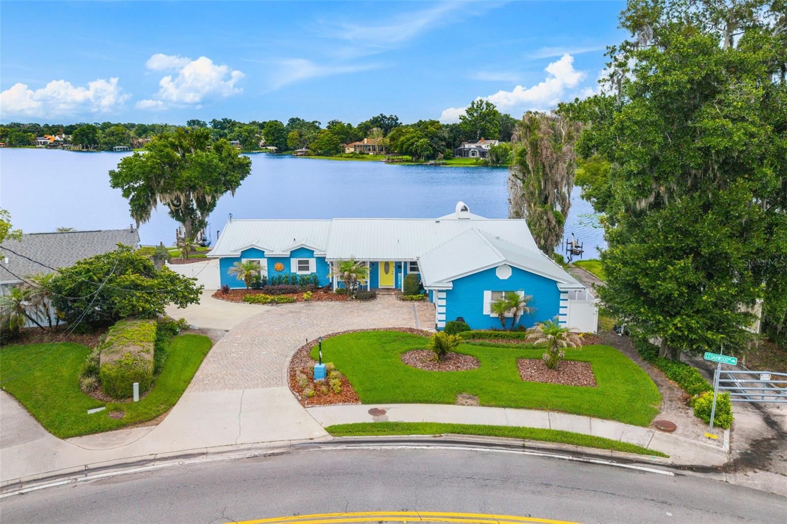 Nestled on the shores of skiable Lake of the Woods, this beautifully maintained 3-bedroom, 2 and a half bath waterfront residence offers over 105 feet of private lake frontage with breathtaking open-water views. Designed for those who embrace the lake lifestyle, the property features a private boat launch, two docks, and a solar-powered boat lift, providing effortless access to one of Central Florida's most desirable private lakes. Inside, vaulted ceilings and abundant natural light create an inviting atmosphere, while the updated kitchen opens seamlessly to the living and dining spaces, making everyday living and entertaining a pleasure. The primary suite enjoys peaceful water views, and the home's coastal-inspired finishes enhance the relaxed lakefront setting. A spacious rear deck overlooks the water and serves as the perfect place to enjoy sunrise coffee, sunset gatherings, and weekends on the lake. Additional highlights include a durable metal roof, wood floors, mature landscaping, generous outdoor living spaces, and a prime Maitland location convenient to shopping, dining, top-rated schools, Winter Park, and Downtown Orlando. Rarely does an opportunity arise to own a move-in ready waterfront home with this combination of frontage, amenities, and direct access to skiable waters.