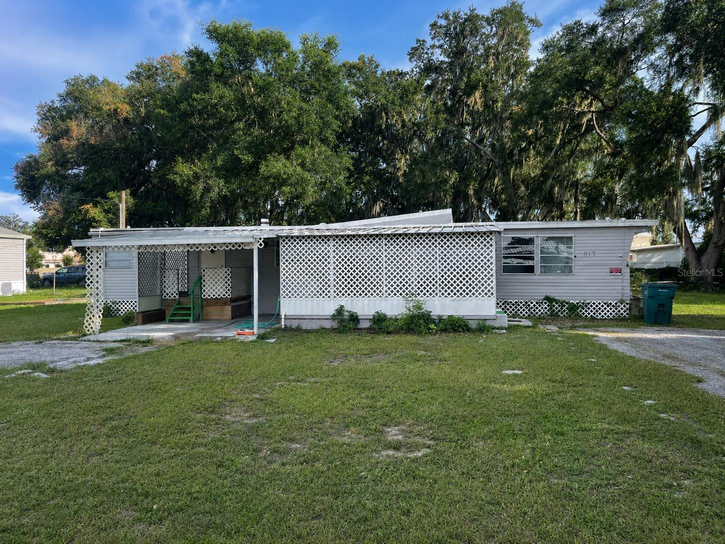 NO LOT RENT..NO HOA..YOU OWN THE LAND! Seller is open to offering Owner Financing. 
This well maintained 2 bedroom, 1 bath 1965 mobile home sits on nearly 1/4 acre and is move in ready with Fresh interior paint, public water, a patio, and two porches, providing plenty of outdoor space to enjoy.
Just a few miles from The Villages and easy access to I-75 and the Turnpike. Schedule your showing today!