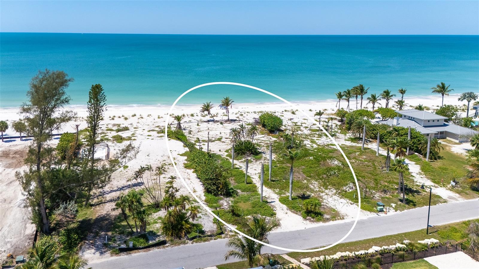 Build your dream beachfront estate on nearly three-quarters of an acre on exclusive North Longboat Key. With 100 feet of private Gulf frontage, this rare homesite offers endless views of turquoise waters spectacular sunsets and direct access to powder sand just steps from your future doorstep. Set within a rising luxury enclave, this prime property is moments from the new St. Regis Resort and the Longboat Key Club, offering world-class golf, tennis, dining, and five-star amenities. Enjoy the charm of nearby Anna Maria Island and the upscale shopping and cultural experiences of St. Armands Circle. This is one of the last opportunities to create a custom beachfront retreat in one of the Gulf Coast’s most coveted locations