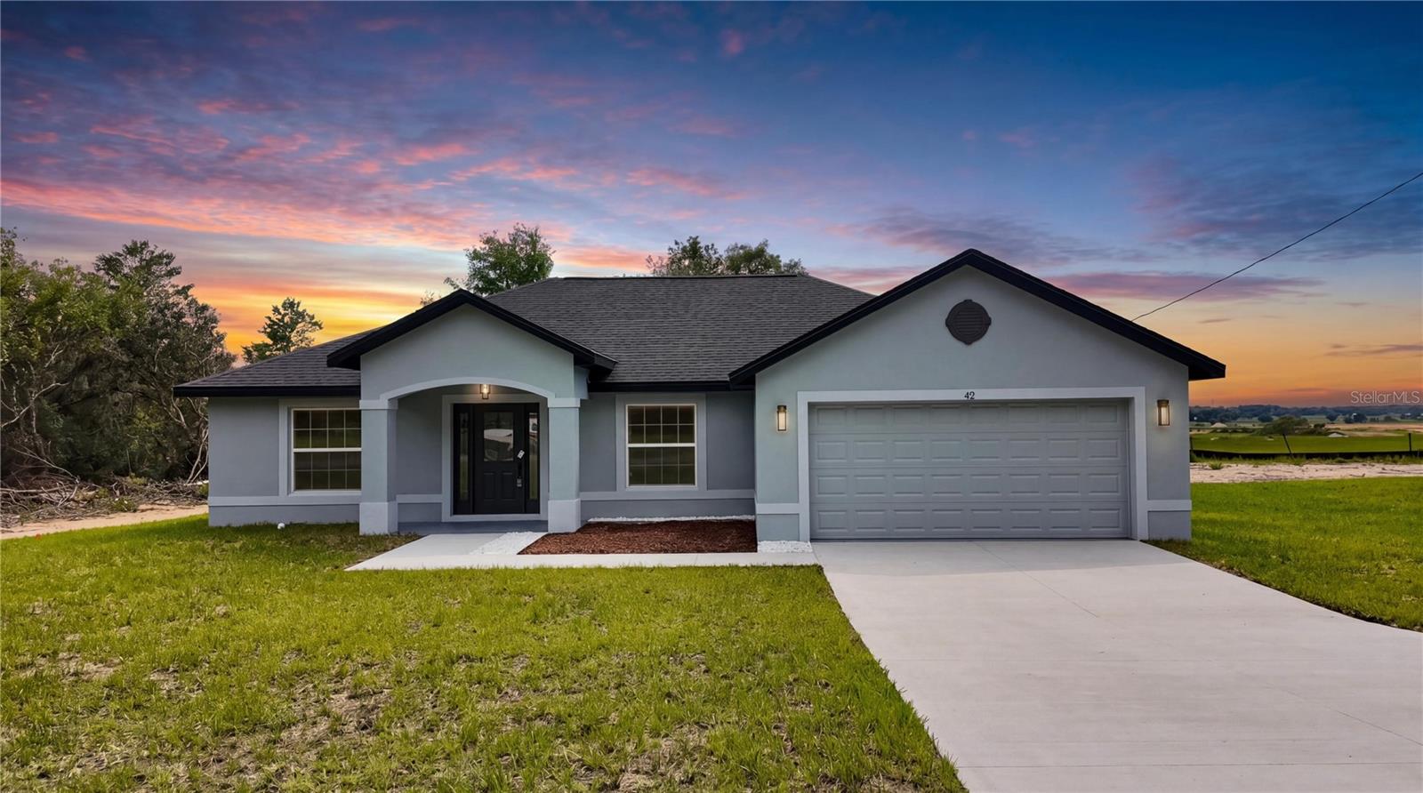 $5,000 Seller Credit Toward Closing Costs! This beautifully crafted new construction home combines modern design, comfort, and functionality. Featuring 3 bedrooms, 2 bathrooms, and situated on an oversized 0.35-acre lot, this property provides exceptional indoor and outdoor living space with plenty of room for a future pool, garden, workshop, or additional outdoor entertaining area.
Step inside to an inviting open-concept floor plan highlighted by soaring vaulted ceilings, abundant natural light, and luxury vinyl plank flooring throughout. The spacious great room seamlessly connects the living, dining, and kitchen areas, creating the perfect setting for both everyday living and entertaining.
The designer kitchen is sure to impress with quartz countertops, a stunning waterfall-style island featuring custom wood accent detailing, stainless steel appliances, modern pendant lighting, a spacious pantry, and abundant cabinetry extending to the ceiling for added storage and a clean, upscale look.
Large sliding glass doors lead to the covered rear lanai, providing the perfect space to enjoy Florida living year-round, whether you're relaxing with your morning coffee or entertaining family and friends.
The spacious primary suite offers a private retreat with tray ceilings, oversized windows, a large walk-in closet, and a beautifully appointed en-suite bathroom featuring dual vanities and quartz countertops. Two additional generously sized bedrooms provide flexibility for family, guests, or a home office. A conveniently located linen closet provides additional storage.
Designed for everyday convenience, the home also features an inside laundry room and a garage with a durable epoxy-coated floor finish for a clean appearance and easy maintenance.
Every detail has been thoughtfully selected to combine modern elegance with practical living. From the designer lighting package and contemporary finishes to the expansive lot and covered lanai, this exceptional home delivers the space, style, and functionality today's buyers are looking for.
Schedule your private showing today and experience the exceptional design, quality craftsmanship, and value this beautiful new construction home provides.