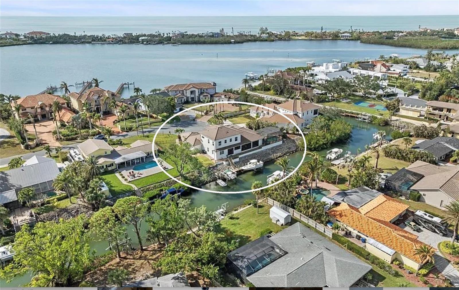Experience the ultimate boating lifestyle from this custom-built waterfront home on a peaceful cul-de-sac.
Sitting high and dry at 12 feet, the home was fully renovated for it’s current owners in 2020. Built well after the 2002 Florida Building Code changes (which required structures to be engineered for improved hurricane resistance, including impact windows, elevated designs and a more stringent building code), gives you peace of mind and makes the home easier to insure than an older home.
An elegant design featuring high ceilings and engineered hardwood floors leads to a stunning outdoor retreat. The home's extensive glass windows and sliding doors create a seamless transition to your oversized entertainment area and screened lanai. This outdoor oasis features a heated saltwater pool, outdoor kitchen with Alfresco built-in grill, built in speakers, propane fireplace and TV—ideal for entertaining against the canal backdrop. With 190 feet of waterfront, one house away from the intracoastal, and no fixed bridges to the Gulf, this property is a boater's paradise. Featuring a 10,000 lb primary boat lift, a 5,000 lb double jet ski lift, a fish station, and a 70-foot Trex dock equipped with water and power.  Whether you prefer boating, kayaking, paddleboarding, fishing, or simply lounging by the pool, this outdoor space is designed for all-day enjoyment.
The chef's dream kitchen was fully remodeled in 2020 with both serious cooks and entertaining in mind, showcasing double islands, quartz countertops, and top-of-the-line Wolf/Subzero appliances, including an induction cooktop, convection microwave, convection steam oven, wine fridge, and an oversized built-in refrigerator. A walk-in wet pantry with an ice maker and espresso machine hookup completes this culinary haven.
The luxurious main floor primary suite features a spa-like bathroom with a double showerhead walk-through shower, a jetted soaker tub, double sinks, and three spacious walk-in closets. Enjoy the seamless transition to the pool area through French doors, or retreat to the connected office adorned with smart electric blinds and built-in desk and cabinetry.  
Upstairs you’ll find two oversized bedrooms, each with its own full ensuite and a loft area with vaulted ceilings and a wet bar. The upstairs provides complete privacy for your family or guests.
Every detail has been carefully crafted, from the tray ceilings and crown molding to engineered hardwood floors and LED lighting. Even the 4 car garage has built in storage, a work bench, high ceilings, epoxy floors and 2 EV charging ports!
Recent upgrades include exterior painting, a new flat tile roof at the end of 2023 (these upgrades alone were over $118,000).  With all major updates already done, there is nothing left to do but move in and enjoy this exquisite waterfront retreat.  Schedule your private tour today.