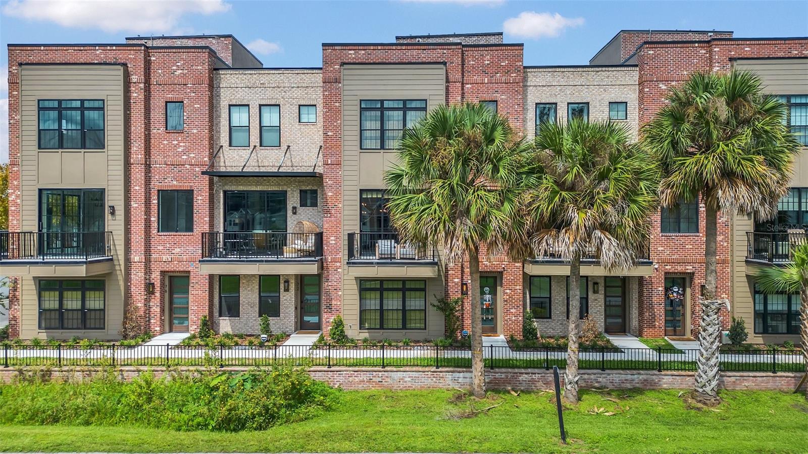The PARK AVE address says it all!! A RARE OPPORTUNITY to own 1 of only 9 EXCLUSIVE townhomes located in the heart of downtown Winter Garden's bustling shopping district.   Unit 60 in the esteemed 30 N Park townhome community offers an exceptional living experience. This corner unit boasts over 3,800 square feet of living space. Its outstanding features include a captivating rooftop terrace designed for entertainment, complete with a pergola, large hot tub, outdoor kitchen, and ample seating. Inside, the home is appointed with 11-foot ceilings on main floor, high end finishes, shiplap accents, an elevator, electric blinds, RH window treatments, and smart home technology. The kitchen is a standout, with oversized windows providing lots of natural light and tree top views, a 12-foot island, high-end appliances, and a walk-in pantry. The open floor plan seamlessly connects the kitchen to the dining and living areas, appointed with wood-beamed ceilings and a gas fireplace with distressed wood accents and antique railroad tie mantle. For those needing a private workspace, the home includes an executive office with oversized glass barn doors. Highlights encompass a large balcony to enjoy the Disney fireworks and scenic views of West Orange Trail. The practical amenities include  two tankless water heaters, a whole house generator, and an oversized two-car garage PLUS one assigned parking space. The master retreat offers ample space with lots of natural light, walk-in closet featuring custom built-ins. The resort style bath offers a soaking tub, dual sinks, and an oversized walk-in shower with floor-to-ceiling tile work. Other notable features of this property include large secondary bedrooms, an en-suite bedroom on the first floor conveniently accessible to the elevator.  The exceptional designed floor plan elevates this residence, offering luxurious living in a prime downtown location, making it a compelling choice for those seeking a sophisticated LOCK AND LEAVE urban lifestyle in Downtown Winter Garden.  There is video surveillance on the property.