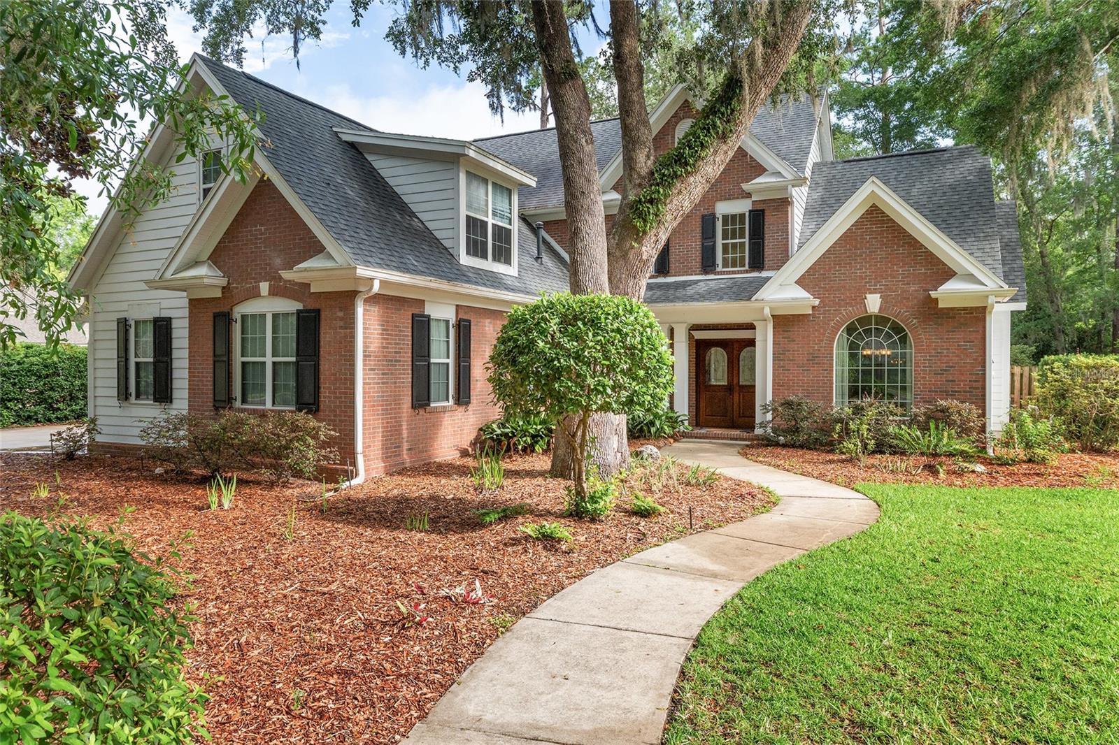 Welcome to this cozy custom-built pool Tom Spain home in the desirable Millhopper Forest community, nestled off scenic Millhopper Road in Northwest Gainesville. This beautifully maintained residence offers the perfect blend of comfort, charm, and functionality, with spacious living areas, thoughtful updates, and a peaceful setting surrounded by mature landscaping. Enjoy the privacy and tranquility of this sought-after neighborhood while remaining just minutes from shopping, dining, parks, top-rated schools, the University of Florida, and UF Health Shands Hospital. 
Situated on a spacious half-acre lot, this exceptional residence offers 4 bedrooms, 3.5 bathrooms, and over 3,000 square feet of thoughtfully designed living space with high ceiling and abundance of natural light that create a warm and inviting atmosphere. Designed with both everyday living and entertaining in mind, the spacious kitchen features granite countertops, stainless steel appliances, a large walk-in pantry, and generous storage, all opening seamlessly to the family room. A cozy breakfast nook overlooks the private backyard, providing the perfect spot for morning coffee.
Just off the kitchen, you'll find a dedicated office with double doors and peaceful views of the pool area—ideal for working from home. The luxurious owner's suite offers a true retreat with dual vanities, a walk-in shower, soaking tub, and an oversized walk-in closet.
Upstairs, three additional bedrooms provide plenty of space for family and guests. Two bedrooms share a convenient Jack-and-Jill bathroom, while the third features a private en-suite bath, making it ideal as an in-law suite, guest retreat, bonus room, or playroom.
Outdoor living is where this home truly shines. Relax and entertain year-round in the screened lanai overlooking the sparkling pool and spa. The professionally refreshed backyard features, a dedicated firepit gathering area, and plenty of room for outdoor activities, all surrounded by mature landscaping for added privacy, offering peace of mind and true move-in-ready convenience
Ideally located near Devil Millhopper park, dining, shopping, and everyday conveniences at Hunter’s Crossing, with easy access to Publix, the University of Florida, UF Health Shands Don't miss this opportunity to make this your new home!!!