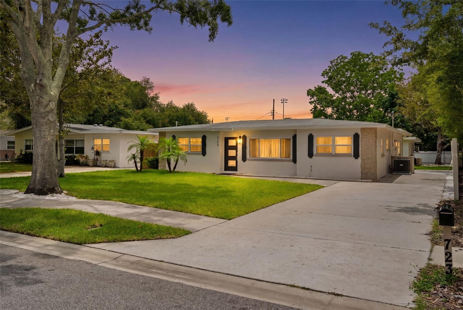 Virtually Staged. Tucked into one of Tarpon Springs' most established neighborhoods, this extensively renovated property offers a rare opportunity to enjoy the charm of a mature coastal community without sacrificing the peace of mind that comes from modern systems, finishes, and infrastructure.

Thoughtfully reimagined from the inside out, virtually every aspect of the property has been improved with careful attention to quality and detail. The main residence showcases all-new flooring, fully remodeled kitchens and bathrooms, updated electrical and plumbing systems, new HVAC, new windows, fresh interior and exterior finishes, new irrigation, fresh sod, and countless additional upgrades throughout. Even the smallest details have been considered, creating a home that feels cohesive, intentional, and truly move-in ready.

At the heart of the home, beautifully designed living spaces flow seamlessly into a stunning kitchen featuring custom cabinetry, quartz countertops, stainless steel appliances, and an oversized island designed for gathering, entertaining, and everyday living. The renovated bathrooms rival those found in much higher price points, while abundant natural light and thoughtful design choices create a welcoming atmosphere throughout.

Beyond the main residence, a detached guest cottage adds exceptional flexibility. Complete with its own kitchen, bathroom, private entrance, and separate electric service, it provides an ideal solution for multigenerational living, extended family accommodations, a private home office, creative studio, caregiver quarters, wellness space, or other long-term lifestyle needs.

The fully fenced property is designed to maximize both privacy and functionality. Mature trees create a peaceful setting, while the spacious yard offers room to entertain, garden, relax, and enjoy Florida's year-round outdoor lifestyle. Together, the main residence and detached cottage create a unique compound-style setting rarely found in traditional residential neighborhoods.

The location further enhances the appeal. Just minutes from Fred Howard Park, Sunset Beach, local marinas, waterfront parks, and the Gulf, residents enjoy easy access to some of the area's most beloved outdoor destinations. Historic downtown Tarpon Springs and the world-famous Sponge Docks are nearby, offering a vibrant mix of restaurants, boutiques, galleries, festivals, and waterfront charm. Schools, shopping, dining, and daily conveniences are all within easy reach.

While short-term rentals are not permitted, the property's detached cottage and separate utilities provide tremendous flexibility for a variety of long-term living arrangements and personal uses.

This is more than a renovated home. It is a comprehensive transformation designed to allow its next owners to simply move in, unpack, and enjoy everything that makes Tarpon Springs such a special place to call home.