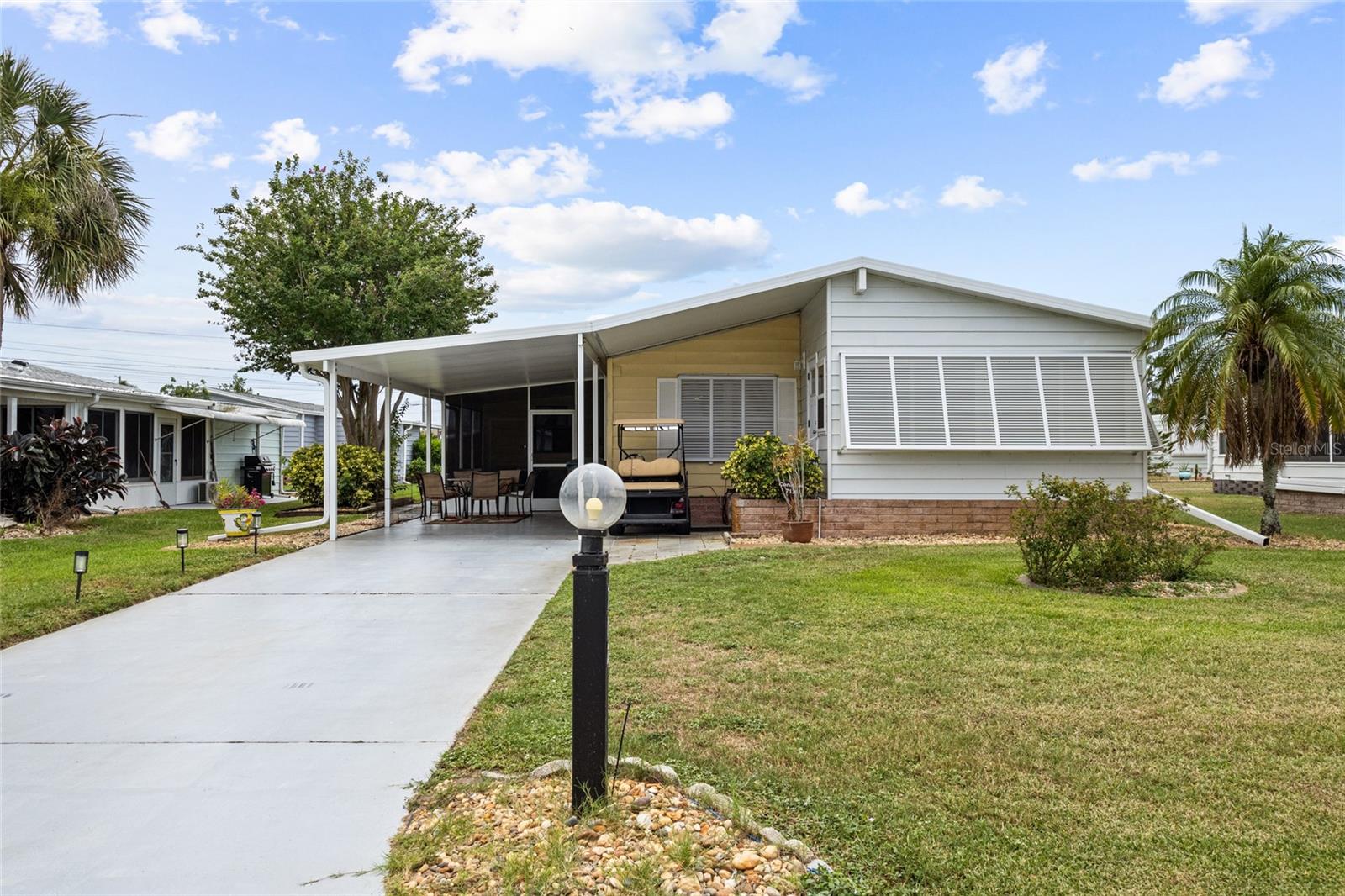 Turn-Key Furnished 2 Bedroom, 2 Bath Home with Stunning Florida Room & Resort-Style Amenities
This beautifully maintained 2 bedroom, 2 bath mobile home is being sold Turn-Key Furnished—just bring your personal items and start enjoying Florida living. All furnishings (most of them brand new), décor, kitchenware, and linens stay. Even the Golf Cart, TVs, TV mounts, and an 8 cu. ft. chest freezer are included.

Step inside to an inviting open floor plan with Luxury Vinyl Plank flooring throughout, except in the second bedroom. The home features a brand-new Florida Room equipped with Hurricane-rated windows, tinted windows, and Hurricane Bahama Shutters, adding both beauty and peace of mind.
Outdoor living is a highlight, with multiple spaces to relax and entertain: A spacious back patio, A screened side lanai, and an additional open lanai.  Recent upgrades include Flooring, Washer & dryer (6 months old), Dishwasher (1 year old), New dining room and kitchen fixtures, New living room ceiling fan, and New Living Room furniture.  Located in the vibrant community of Tangerine Woods offering a clubhouse, pool, fitness center, shuffleboard, tennis, and pickleball, this home blends comfort, convenience, and an active lifestyle.  Whether you're seeking a seasonal retreat or a full-time residence, this turn-key gem is ready for you to move right in and enjoy.