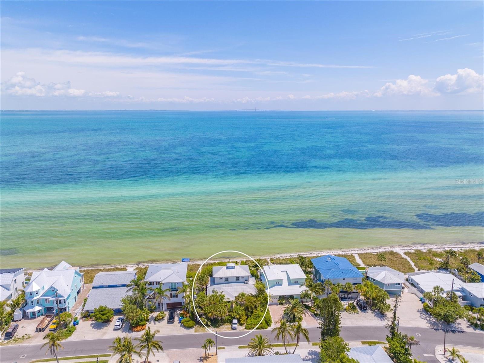 Looking for that perfect hideaway home featuring one of the best views on the West Coast of Florida? Look no further. This 3 bedroom, 2.5 bathroom + den has the very utmost privacy while still being direct Bayfront with unobstructed views! Upon entering the front gate, you'll be pleasantly surprised by the lush landscaping surrounding while following a bricked pathway to the front door. Entering through the custom arched wood door that are also throughout the home, you are greeted by stunning views of the gorgeous water with Tampa Bay and the Sunshine Skyway directly ahead which include a nightly light show. The open concept and eat-in island are ideal for entertaining guests. There are built in, floor to ceiling bookshelves and a huge living / dining room area. One can enjoy watching inspirational sunrises in the morning from inside or relaxing on the spacious decks. Enjoy the entire upstairs as your master suite with your own private deck. This home is private, stunning views, natural light that overall creates an eclectic and warm vibe. You will fall in love as soon as you walk in. Schedule your private showing today! Seller will consider owner financing.