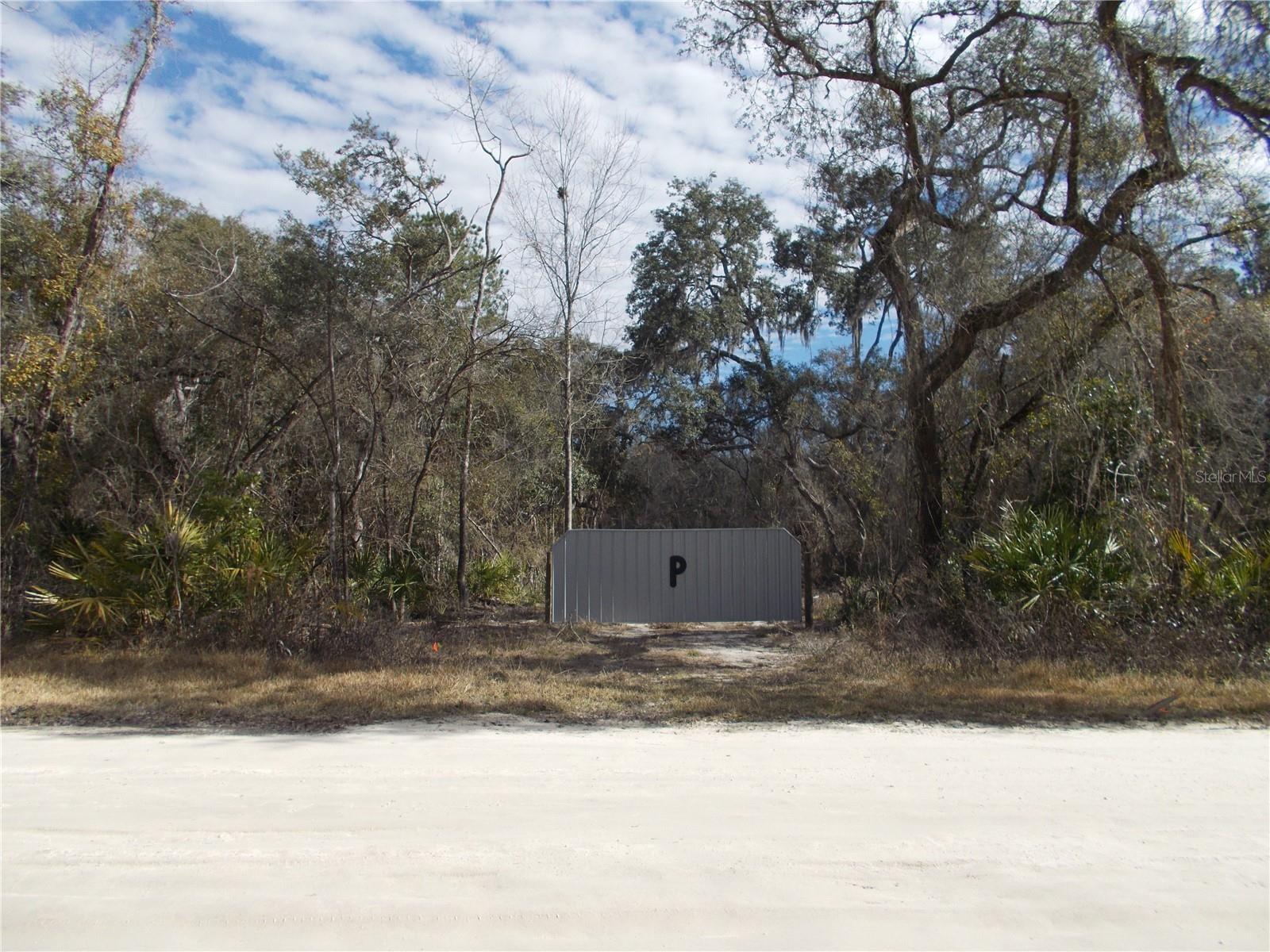If you are looking for a HOME SITE to build your Dream Home on a property located in this rural quiet community of Old Town you may have found it!! Discover your own piece of paradise with this partially cleared property with 1.83 acres. The property has been partially cleared in the center of the property which gives you lots of privacy.  The property has a driveway with a Front Gate that leads you to the clearly that has a  4' well and new house pad all ready for you to build your new home and were you can find a perfect balance of peaceful, rural living and easy access to all that North Central Florida has to offer. With NO HOA restrictions, you have the freedom to truly build your dream, whether it's a custom site-built home, a modular home, or a personal weekend retreat. Imagine designing a space with plenty of room for a garden, a detached workshop, or just the space to breathe. This partially improved land, you get to install brand new utilities exactly where you want them, ensuring a custom setup tailored to your home. This prime location places you close to the area's most beautiful natural treasures, including the famous Suwannee River and Fanning Springs State Park, making kayaking, snorkeling, and enjoying the outdoors a regular part of life. Seize this opportunity to escape the city and embrace the quiet, flexible lifestyle of Old Town! Call today for a showing today!!