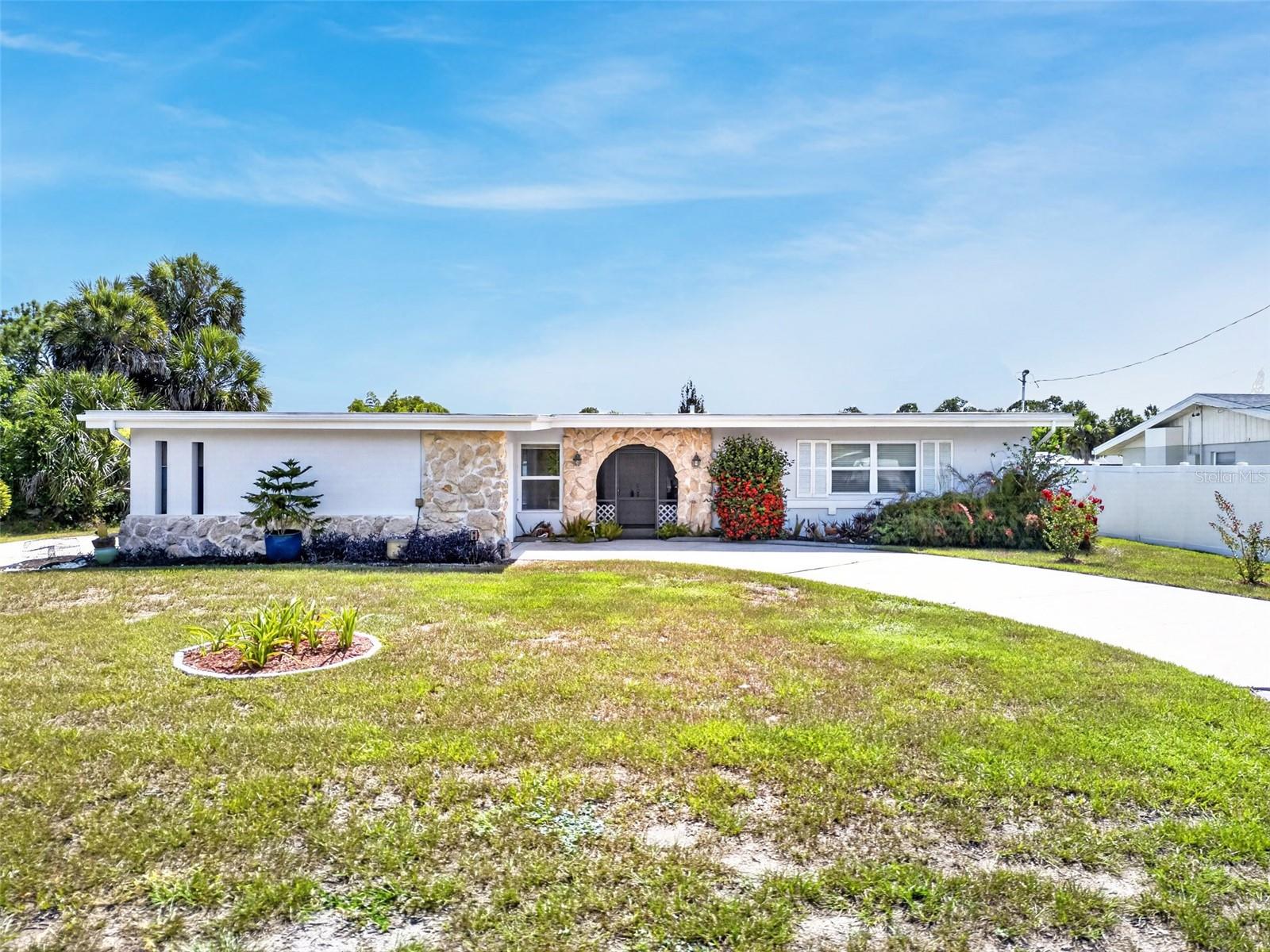 REMODELED AND MOVE IN READY! Updated 3 bedroom, 2 bath, 1-car garage waterfront home with QUICK BOATING ACCESS to Charlotte Harbor leading to the Gulf! For the avid boater, this property features 80’ of waterfrontage on a deep-water wide canal offering concrete dock with electric plus new seawall and 10,000 lb. boat lift in 2023. Seller updates also include new garage door, exterior paint, insulation plus 8’x10’ aluminum shed in 2022 and new A/C in 2023. Enclosed lanai features new sliding windows and offers tile flooring, sunshade and is a great space to enjoy the water views and amazing sunsets year-round rain or shine.  The kitchen has been beautifully modernized with ample white cabinetry, stylish subway tile backsplash, stainless appliances and center island with breakfast bar. Living room, kitchen and all bedrooms have been updated to laminate flooring. Step inside to an open floor plan with vaulted ceilings plus large windows and sliders providing plenty of natural light for the living and dining areas. Generous primary suite features dual closets and private bath with walk-in shower, complemented by two comfortably sized guest bedrooms and an updated full guest bath.
 Additional special features include inside laundry room, covered screened front entry, outdoor patio for barbequing and convenient walkway to dock and separate driveway with plenty of room to park your boat or RV. Enjoy the freedom of no HOA fees or deed restrictions. This property offers an excellent location close to the Murdock restaurant and shopping district, Charlotte Beach Park, and local schools. Historic downtown Punta Gorda, known for its community events, parks, and world-class fishing, is just a short drive away. An ideal property for a permanent residence or a seasonal retreat.