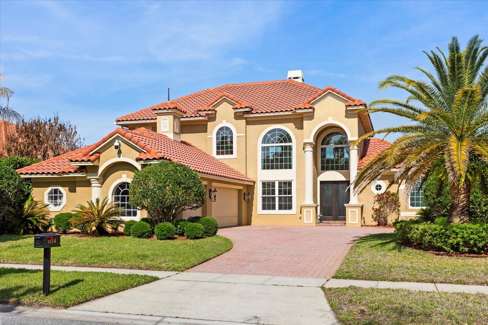 Price Improvement!  Located behind the gates of the prestigious Reserve at Belmere in sought-after Windermere, this exceptional Mediterranean-inspired estate offers a rare blend of timeless architecture, modern luxury and thoughtful custom enhancements. Built in 2004 by the original owners and expanded during construction, the residence offers more than 3,427 square feet of refined living space and over 4,528 total square feet, creating a larger footprint than many comparable homes within the community. Extensively upgraded with more than $250,000 in recent improvements, this meticulously maintained home showcases true pride of ownership. Significant updates completed within the last three years include three new Trane HVAC systems, replacement windows, premium appliances, pool renovations, designer lighting and numerous interior and exterior enhancements. From the moment you enter, soaring 24-foot ceilings and elegant architectural details set the tone. Crown molding, coffered ceilings, engineered hardwood flooring, custom window treatments and a marble wood-burning fireplace create a sophisticated yet inviting atmosphere. Expansive glass sliding doors frame the outdoor living spaces and provide seamless indoor-outdoor flow ideal for everyday living and entertaining. Integrated ceiling speakers and a dedicated executive office further elevate the home’s functionality and lifestyle appeal. The chef’s kitchen has been thoughtfully curated with luxurious quartzite countertops, custom pullout cabinetry with rotating shelving systems and an impressive suite of premium German appliances, including a Miele built-in coffee system, convection oven, dishwasher and refrigerator. A professional-grade 48-inch chef gas range with six burners and a griddle, custom lighting and a built-in three-stage water filtration system complete the space. Privately on the main level, the primary suite offers a tranquil retreat with coffered ceilings, newly installed commercial-grade carpeting, serene pool views and direct patio access. The spa-inspired primary bath is appointed with marble and travertine finishes, a soaking tub, a separate shower and custom walk-in closet built-ins. Upstairs, generously sized secondary bedrooms and a spacious loft overlook the formal living and dining areas below. Designed for elevated outdoor living, the resort-style backyard features a resurfaced saltwater pool and spa, an updated pool heater, decorative fountains, remote-controlled pool systems and multiple entertaining areas surrounded by lush European-inspired landscaping, stone pathways and manicured grounds. Canary palms and mature landscaping create a private, luxurious setting. Additional highlights include a new front entry door, an oversized three-car garage, an upgraded security system, a partial roof replacement and designer chandeliers and lighting throughout. Ideally located in one of Windermere’s premier gated communities, residents of Reserve at Belmere enjoy convenient access to top-rated schools, dining, shopping, golf, major roadways and the area’s renowned luxury lifestyle offerings.