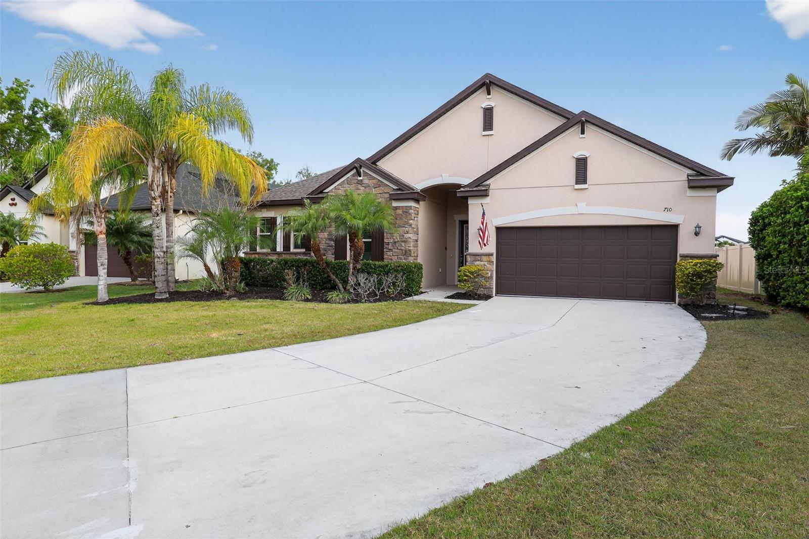 One or more photo(s) has been virtually staged. Welcome to the Raven Crest Community, and this stunning rambler.  Situated on a tucked-away cul-de-sac you'll enjoy pond views from the privacy of your swimming pool surrounded by a classic paver patio and covered by your lanai.  Imagine the cool refreshing water washing away the stress of the day in the heat of summer.  The gourmet kitchen boasting quartz countertops, walk-in pantry, stainless appliances  and expansive center island will have you searching for new recipes to try when you entertain friends and family.   A spacious floor plan with crisp white trim and charming tile floors give this property a welcoming personality.  There are 4 bedrooms with walk-in closets including an owners suite that feels like a staycation.  Enjoy a spa like bath with a walk-in glass & tile shower, garden tub perfect for a long relaxing soak, dual sinks with ample cabinet & counter space for each.  3 additional bathrooms ensure privacy for residents and guests alike.  You'll love the convenience of a bath off the pool.   A tandem garage with a total of 3 parking spaces means you have room for a boat, golf cart, a shop of more toys.  Enjoy all that the gulf coast has to offer including white sand beaches, fishing, boating, great food and memories in the making.  Welcome Home!