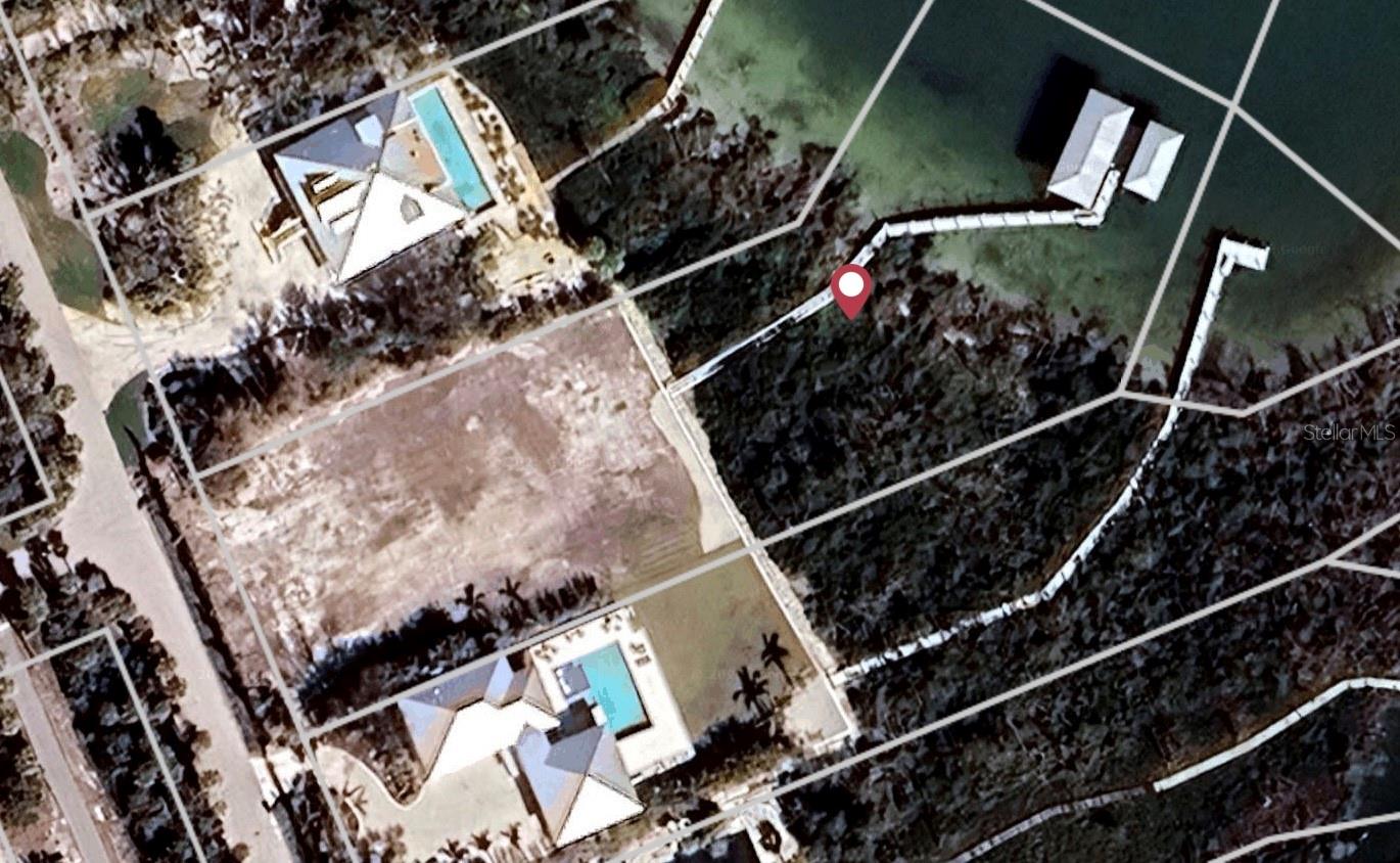 Great location with a deep water, very well, protected dock on over an acre of land... directly across from the Boca Grande Club. You can build your Waterfront Dream Home