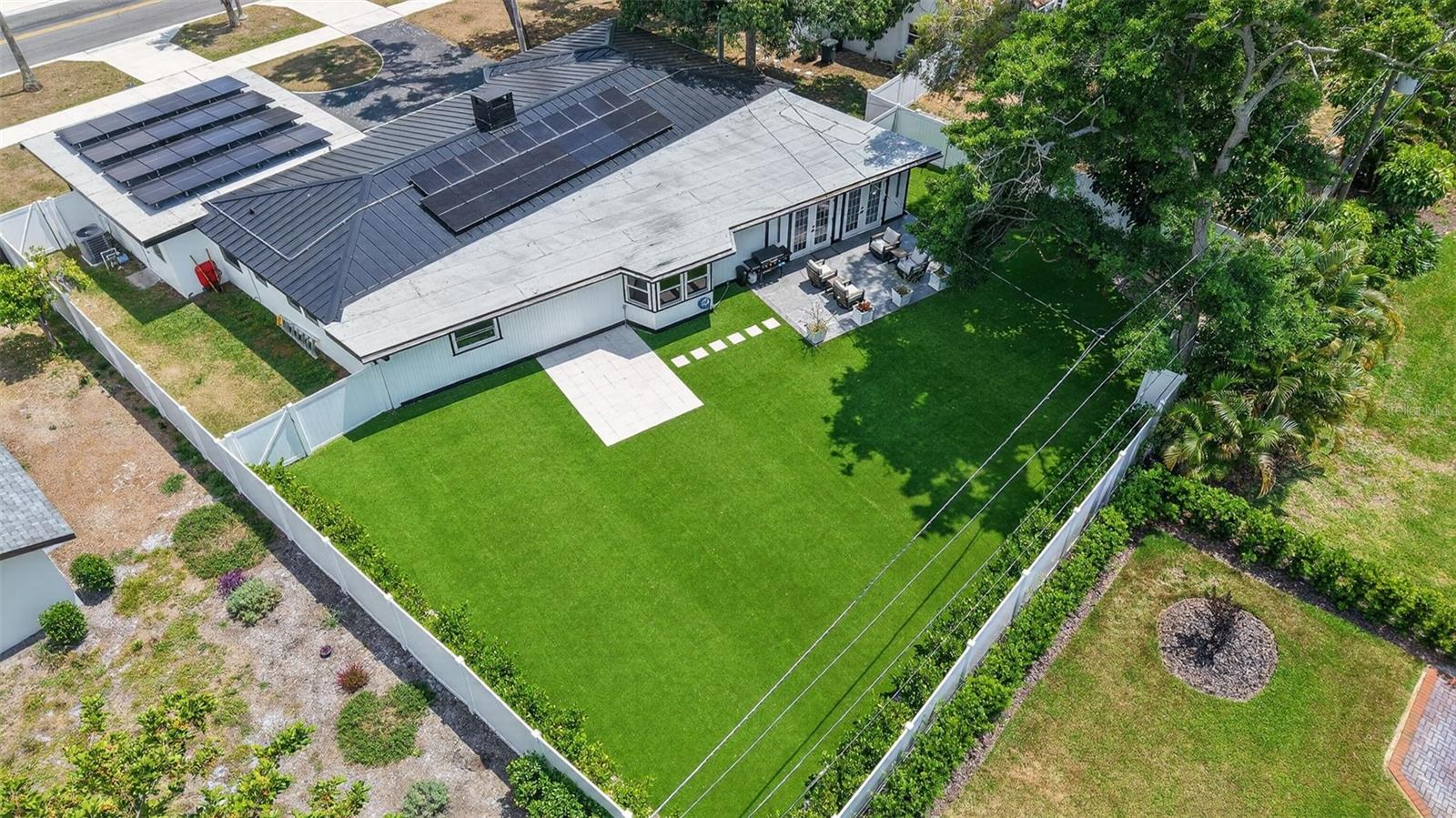 One or more photo(s) has been virtually staged. WELCOME HOME!! Discover this refined, 3 bedroom 2 full bathroom move-in-ready home in the heart of Belleair. Set on a generous .28-acre lot a stone’s throw from Pelican Golf Course and minutes from the renowned Belleair Country Club, this beautifully updated modern residence blends thoughtful design with high-end systems and finishes. Enter into bright, open living spaces graced by light oak luxury vinyl floors and a striking wood-panel centerpiece. The kitchen is a chef’s delight — exposed beams, a striking veneer accent wall, large center island, quartz countertops, built-in oven/microwave and brand-new stainless-steel appliances — flowing directly to an ample back patio for effortless indoor/outdoor living and entertaining. A dedicated wet bar enhances hosting possibilities. The primary suite is a restful retreat with a sizeable walk-in closet and a spa-like en suite featuring dual vanities and a spacious glass-enclosed walk-in shower. A practical split-plan places two guest bedrooms on the opposite side of the home with a beautifully renovated full bath. Practicality meets peace of mind with the property located NOT IN A FLOOD ZONE and extensive recent infrastructure upgrades: new metal roof with 2025 upgrades, solar panels, new electrical mast and grounding, upgraded electrical throughout, new HVAC (2025/26), new water heater, new hurricane-proof front and garage entry doors, ductless mini-split in the kitchen, updated ductwork, new tile and appliances in the kitchen, new closet systems, full turf and landscaping, exterior pressure wash and paint (2026), and more. Beyond the home, enjoy immediate access to Belleair's best — beaches, Belleair Market and Publix, fine dining, parks, boat ramp, dog beach, and Morton Plant Hospital. Whether you’re seeking an elegant primary residence or a luxurious second home, this property offers exceptional value in one of Belleair's most desirable locations. Don’t miss this opportunity — schedule your private showing today! *Sellers are Offering buyer's $10k towards closing costs or Rate Buy down*
