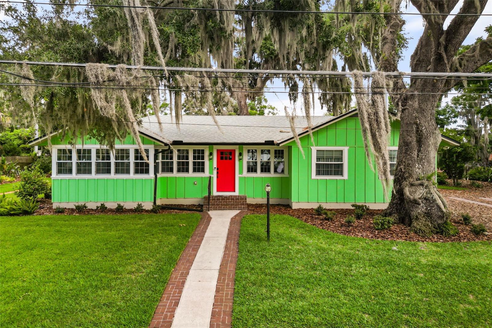 Moments from historic downtown Mount Dora, this thoughtfully updated residence on Heim Road offers views of Lake Gertrude and a seamless blend of modern enhancements with timeless character. Situated on a 0.28-acre homesite with no homeowners association, the two-bedroom, two-bath home spans 1,762 square feet and features extensive renovations throughout. Natural light fills the interior through insulated thermal windows installed in 2022, complementing the luxury vinyl plank flooring throughout the residence. A spacious living room welcomes guests upon entry, while a formal dining room and sunroom overlooking Lake Gertrude provide inviting spaces for everyday living and entertaining. The remodeled kitchen is appointed with granite countertops, a subway tile backsplash, stainless steel appliances, a gas range, a coffee bar and extensive cabinetry with glass-front upper cabinets and abundant drawer storage. Both bedrooms offer en-suite bath access, including a generously sized primary suite. The fully renovated baths feature granite vanity countertops and updated finishes. Additional interior features include an indoor laundry room with pantry storage, a natural gas tankless water heater and a crawlspace encapsulation system installed in 2022 with a dehumidifier and positive-pressure insulation system. Outdoor spaces showcase mature landscaping, curated gardens, a covered rear porch and a fountain feature. An 8-by-12-foot detached storage shed provides additional functionality. Major system updates include a new roof in 2025, electrical panel replacement in 2017, insulated thermal windows in 2022 and a 2024 air-conditioning system featuring ultraviolet light filtration, humidity control and Ecobee smart thermostat technology. Conveniently across from Lake Gertrude and near the shops, dining and cultural attractions of downtown Mount Dora, this property offers an exceptional opportunity to enjoy one of Central Florida’s desirable lakefront communities. Premier Sotheby’s International Realty. Each office is independently owned and operated. Equal Housing Opportunity.