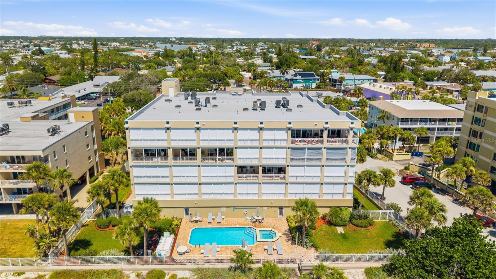 Experience coastal luxury at its finest in this fully renovated Gulf-front penthouse on the coveted southwest corner of Chez Soleil, one of Indian Rocks Beach's most exclusive boutique beachfront communities. Offering 2,175 square feet of refined living space, this exceptional 3-bedroom, 3-bath residence combines breathtaking panoramic Gulf views, designer finishes, and the privacy of a low-density 16-unit condominium. Completely renovated in 2025, this stunning penthouse features large-format 6-foot porcelain wood-plank tile flooring throughout, new windows and sliders, new front door and screen, fresh interior paint and trim, designer lighting, premium Delta® Lumicoat™ fixtures engineered to resist water spots and mineral buildup, electric storm shutters, water softener and purification system, alarm system, and all-new KitchenAid stainless steel appliances. Additional improvements include a new roof, while the HVAC was replaced in 2023. Designed to live like a single-family home, each bedroom occupies its own private corner of the residence. Two spacious guest suites are positioned near the entry. The first offers Gulf views, private balcony access, a walk-in closet with built-ins, and a beautifully renovated ensuite bath. The second features abundant natural light, a walk-in closet with system, and a fully renovated bath with floor-to-ceiling tile, marble waterfall accent, and designer finishes. At the heart of the home, the spectacular chef's kitchen overlooks the living and dining areas while capturing unobstructed Gulf views. Highlights include custom two-tone cabinetry with full-extension pull-out shelving throughout, a dramatic double-waterfall island, hammered farmhouse sink, imported Italian botanical porcelain mural backsplash, built-in refrigerator, wall oven, microwave, vent hood, pantry, breakfast bar, and a nearby utility room with new Whirlpool pedestal washer and dryer. The expansive Gulf-front primary suite is a private retreat with direct wraparound balcony access through double doors. The luxurious spa bath features dual vanities, a 7-foot fog-resistant mirror, heated smart bidet toilet, custom walk-in closet, and an impressive walk-in shower with a floor-to-ceiling botanical hexagon porcelain mural, marble mosaic flooring, dual rainfall shower heads, frameless glass, built-in bench, recessed lighting, and skylight. Floor-to-ceiling glass, soaring 9+ foot ceilings, and three skylights flood the residence with natural light while framing endless Gulf views. The impressive 32' x 10' wraparound southwest corner balcony offers front-row seats to spectacular sunsets and miles of pristine shoreline, while a second private balcony serves one guest suite. Built in 2000 with steel-reinforced poured concrete construction, Chez Soleil offers a secured air-conditioned lobby, heated beachfront pool and spa, private beach access, and a quiet beachfront setting with no road noise. Penthouse 401 includes three dedicated parking spaces—two under-building garage spaces and one exterior space. High-end furnishings are included, creating a truly turnkey opportunity. With pet-friendly policies, 30-day minimum rentals, low monthly maintenance fees, and a walkable location just steps from charming restaurants, cafés, boutiques, and local shops, this extraordinary penthouse offers the perfect blend of luxury, convenience, and beachfront living. Every day begins with the sound of the waves and ends with an unforgettable Gulf sunset.