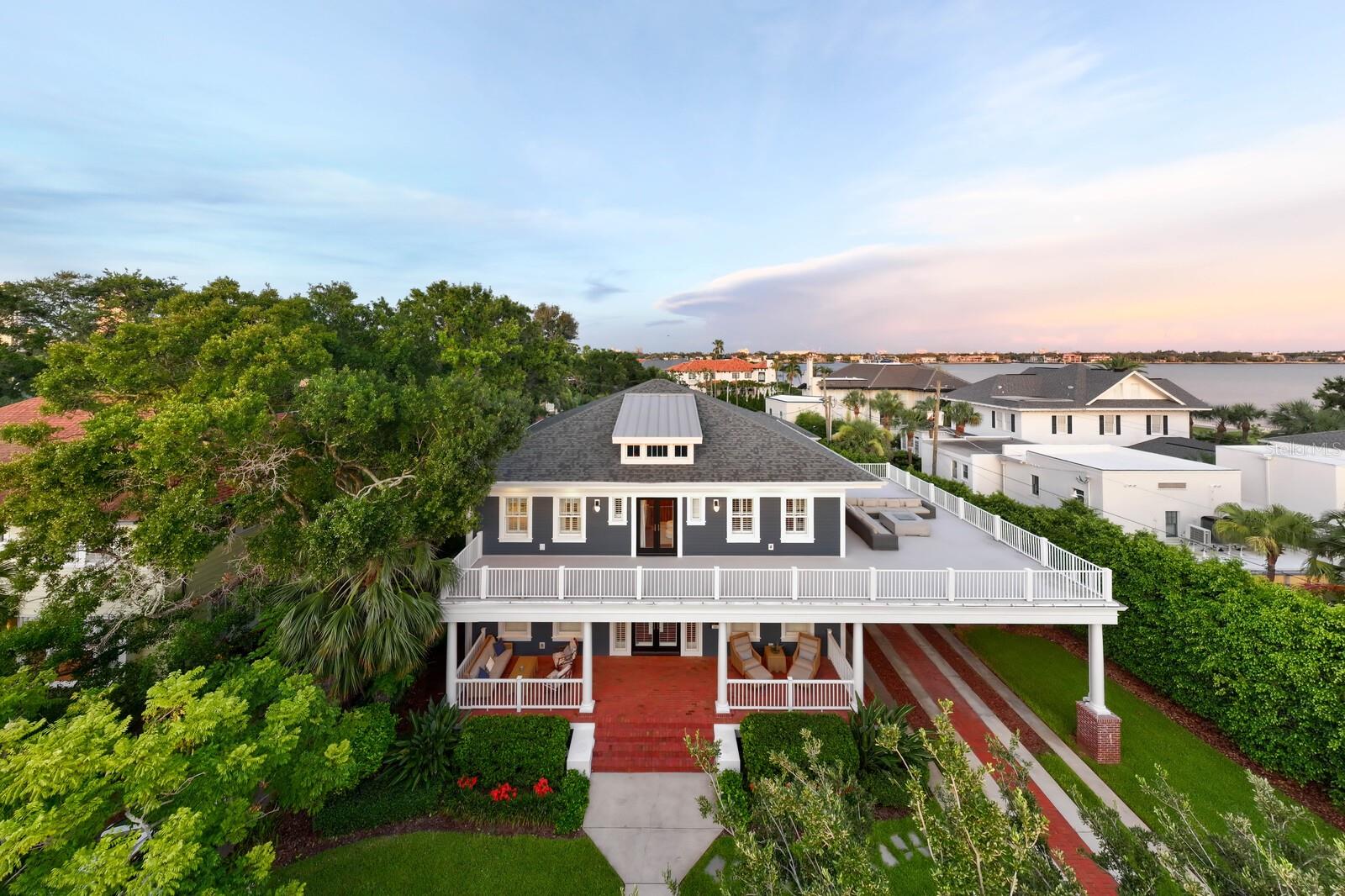 Welcome to 826 S. Edison Avenue, an extraordinary luxury residence in the coveted Golden Triangle of Hyde Park, one of Tampa's most exclusive and desirable neighborhoods. Just steps from iconic Bayshore Boulevard, this exceptional estate offers a rare opportunity to own a newer, non-historic home in Hyde Park—allowing future owners the flexibility to renovate, expand, or customize without the restrictions often associated with historic properties.  Spanning more than 5,200 square feet, this impeccably designed residence combines timeless architecture with modern luxury. Featuring five spacious en-suite bedrooms, 6.5 bathrooms, a private accessory dwelling unit (ADU), dedicated office, bonus room, loft, and fitness space, the home offers an ideal floor plan for everyday living, entertaining, and multi-generational accommodations.  Every detail has been thoughtfully curated with elevated finishes and exceptional craftsmanship. Rich hardwood flooring, extensive custom millwork, designer lighting, built-in cabinetry, and custom closet systems create a sophisticated yet comfortable atmosphere. The chef's kitchen is a true showpiece, appointed with premium appliances, custom cabinetry, and an oversized island that flows effortlessly into the expansive great room, creating the perfect setting for entertaining on any scale. A fireplace anchors the formal dining room, adding warmth and elegance for intimate gatherings.  Set on an oversized lot, the private backyard rivals the finest luxury resorts. Enjoy a sparkling pool, fully equipped outdoor kitchen, dedicated pool bath, covered lanai, lush landscaping, and a private putting green—designed for effortless Florida living. Multiple balconies capture beautiful water views and provide peaceful outdoor retreats throughout the home.  Beyond its stunning design, this residence has been meticulously maintained and thoughtfully upgraded with four HVAC systems, new ductwork, an instant hot water heater, water softener, whole-home dehumidifier, new roof, new gutters, and a freshly painted exterior completed in 2024, providing peace of mind for years to come.  One of the home's most exceptional features is its location. Nestled on one of Hyde Park's most picturesque streets, you're just moments from Bayshore Boulevard, Hyde Park Village, and some of Tampa's finest restaurants, boutiques, coffee shops, and nightlife. Leave the car behind and enjoy one of the city's most walkable luxury neighborhoods while remaining minutes from Downtown Tampa, Water Street, Tampa General Hospital, and Tampa International Airport.  Located within the highly rated Plant High School district, this is a truly rare opportunity to own a large luxury home in the heart of Hyde Park that offers modern construction, premium finishes, exceptional outdoor living, and unmatched walkability in one of Tampa Bay's most sought-after locations.