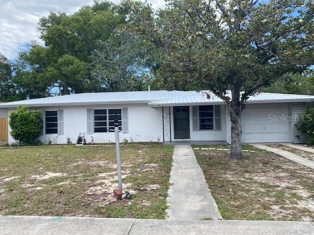 Built in 1971, this 3-bedroom, 1.5-bath home offers 1,128 square feet of opportunity and character. Featuring classic terrazzo floors throughout, this home is ready for someone to bring their vision and personal touch. The metal roof was replaced just one year ago, providing long-term durability and peace of mind. The AC is older but currently functioning. One of the bathrooms showcases a charming retro pink design that adds vintage flair. Step outside to a spacious backyard backing up to a natural retention area, offering added privacy and a peaceful setting. Whether you're an investor, first-time buyer, or someone looking for a renovation project with solid bones, this property has plenty of potential. Sold AS-IS for sellers convenience.