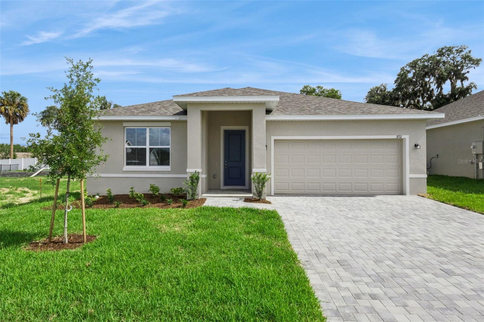 Welcome to The Lucas floor plan, a beautifully designed new construction home located in the quiet & serene Grand Isle community. It offers 4 bedrooms, 2 bathrooms, a 2-car garage, and 1,850 sqft of thoughtfully designed living space, combining modern style, quality craftsmanship, and exceptional value. From the moment you arrive, you'll appreciate the impressive curb appeal featuring a Flagstone® paver driveway, exterior coach lighting, professionally designed landscaping, St. Augustine sod, and a full-coverage irrigation system. Step inside and discover a bright, open-concept floor plan enhanced by ?t?he 9'4" ceilings and abundant natural light. The heart of the home is the spacious kitchen, complete with granite countertops, ?modern white cabinetry, stainless steel appliances, a large center island, and a walk-in pantry. Designed for both entertaining and everyday living, the kitchen flows seamlessly into the dining and family rooms, creating a warm and inviting gathering space. The private primary suite offers a peaceful retreat with a spacious walk-in closet and an en-suite bathroom featuring dual sinks and a large walk-in shower. Three additional bedrooms provide flexibility for family, guests, a home office, or hobbies. Tile flooring throughout the main living areas and bathrooms adds both style and durability, while a dedicated laundry room provides extra convenience and storage space. Enjoy Florida living year-round on the covered rear patio, perfect for relaxing, grilling, or spending time with family and friends. Additional builder upgrades include granite countertops throughout, a garage door opener, quality finishes, and thoughtful details designed to make everyday life easier. Located within Grand Isle, residents enjoy low HOA fees and no CDD, all while being conveniently close to historic downtown Eustis, Mount Dora, shopping, dining, parks, and the beautiful Harris Chain of Lakes. Buyers can also enjoy added peace of mind with a 10-Year ?RWC Warranty and ?a?dded builder incentives that can help lower closing costs, buy down interest rates, or enhance the homebuying experience. Discover the difference of a Summerpark Home—where upgraded features, larger homesites, and exceptional value come standard.